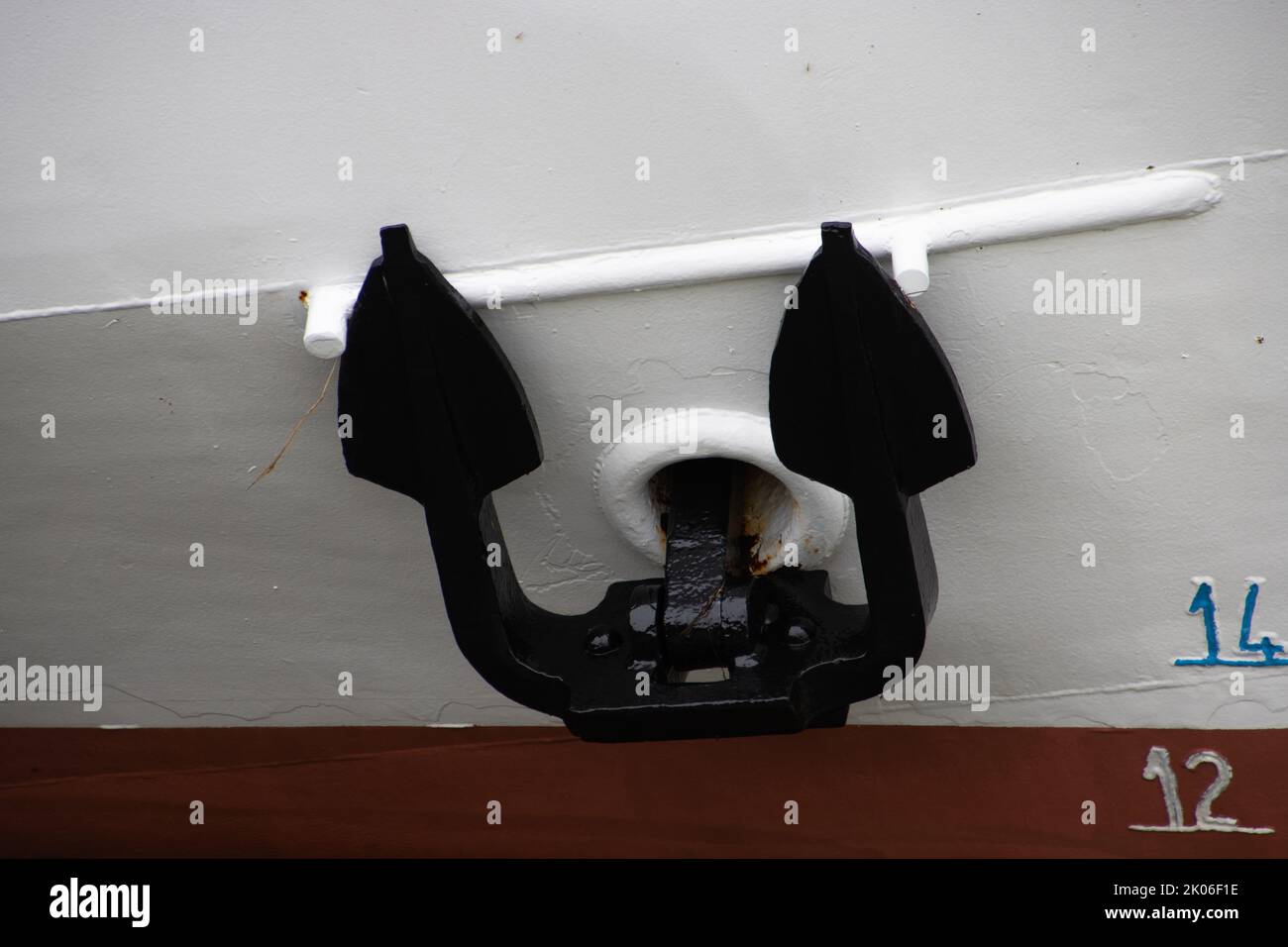 Black anchor on a white ship hull Stock Photo