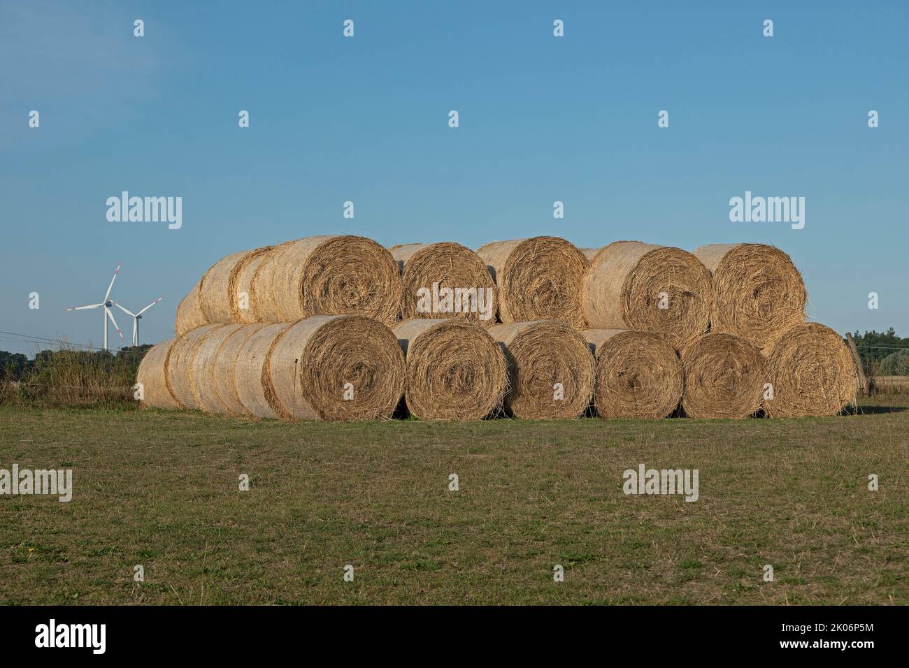 round bales of straw, wind engines, Allerstorf, Marlow, Mecklenburg-West Pomerania, Germany Stock Photo
