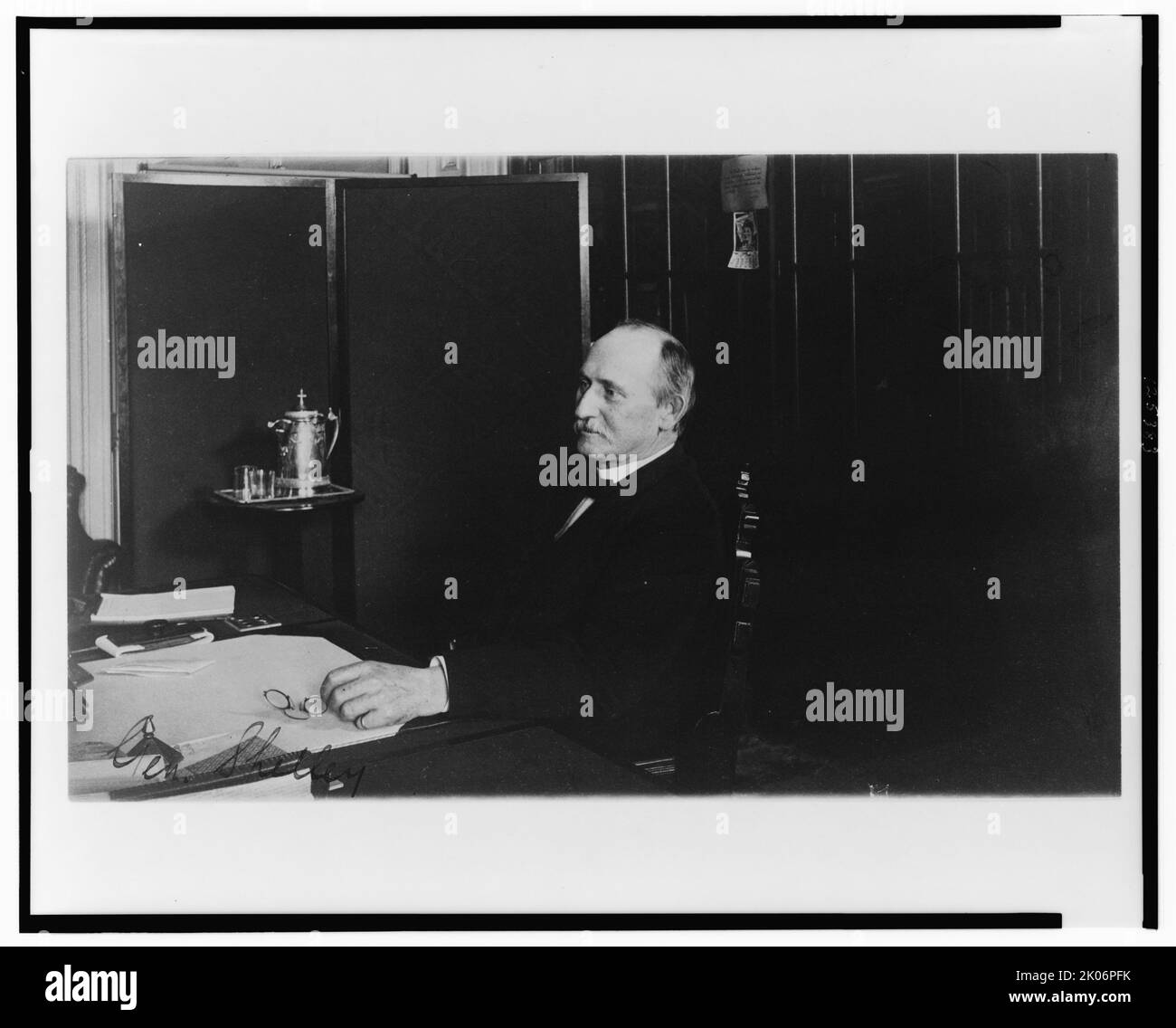 Gen. Shelley, Treasury Department employee, half-length portrait, seated at desk, facing left, between 1884 and 1930. Stock Photo