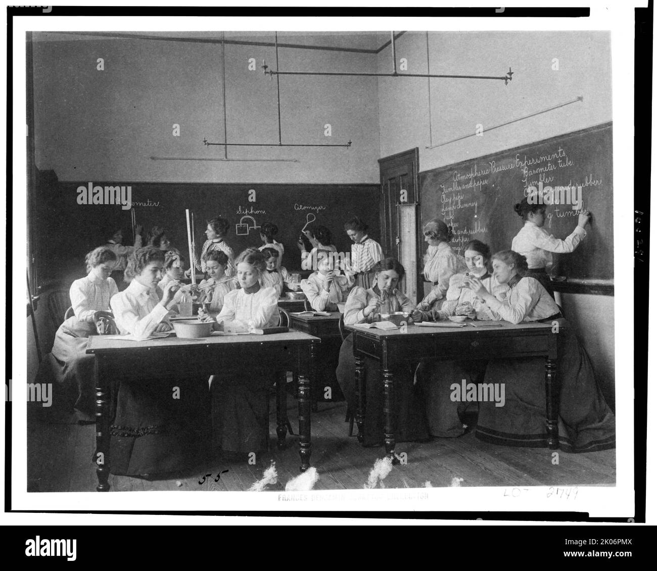 Group of young women performing atmospheric pressure experiments while studying science in normal school, Washington, D.C., (1899?). Stock Photo