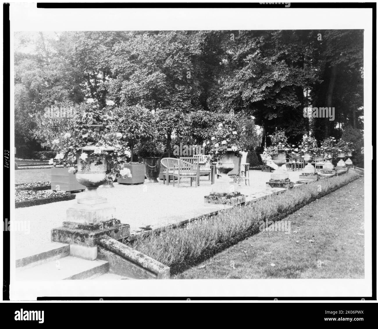 A Shaded gravelled terrace, screened by orange trees, with chaise lounges [sic], settees and tables, at Pavilion Colombe, Mrs. Edith Wharton's villa, St. Brice-sous-For&#xea;t, France, 1925. Stock Photo