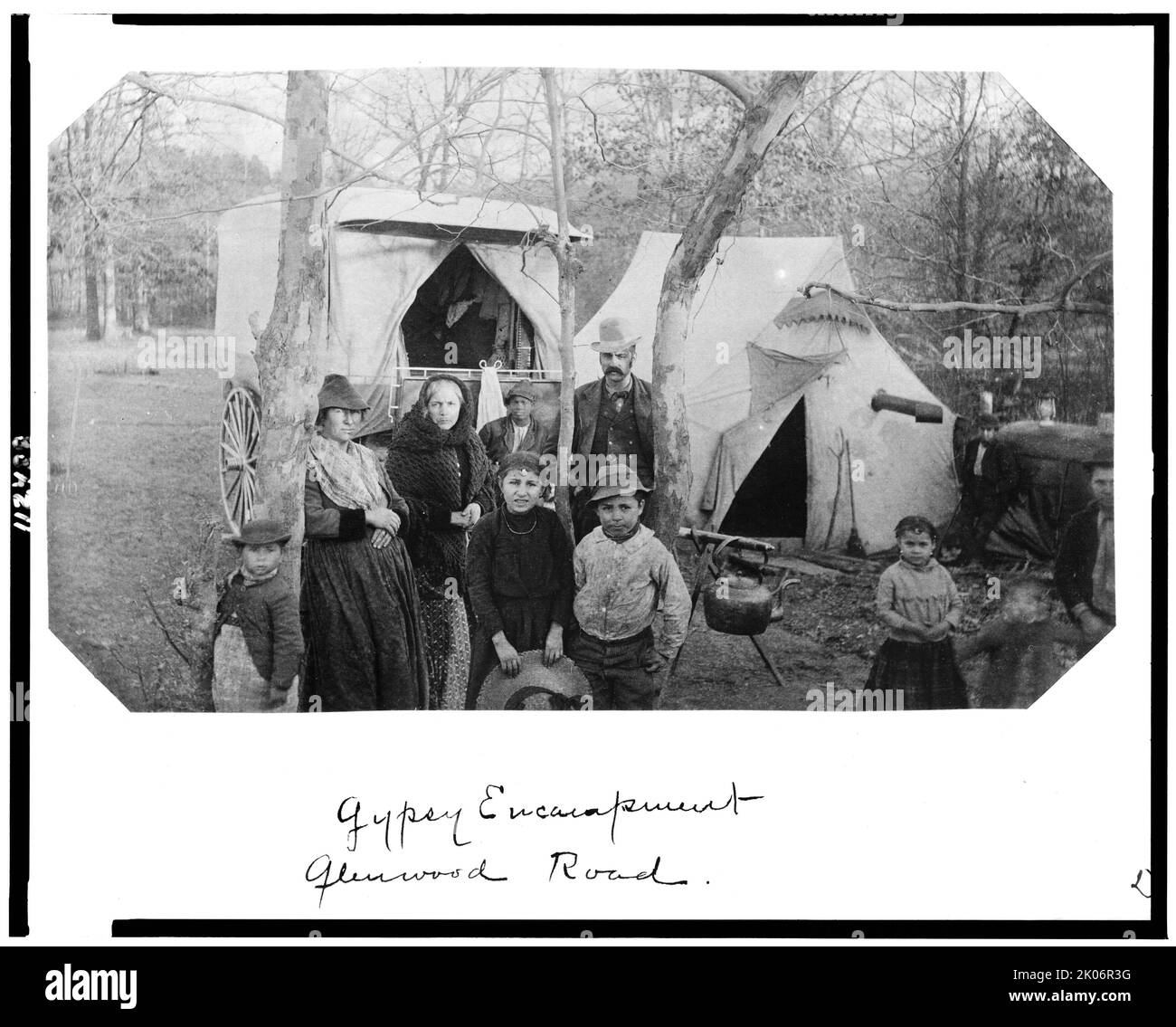 Gypsy encampment Glenwood Road, 1888. Men, women, and children with tent and wagon on Glenwood Road, probably in Bethesda, Maryland. [Note African American boy in background, hole in tent for stove flue]. Stock Photo