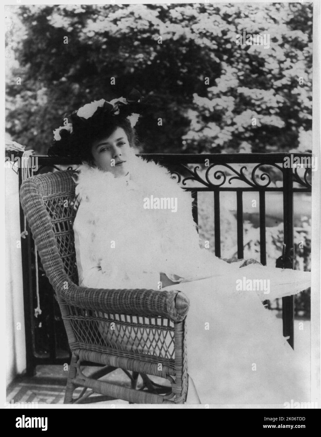 Alice Roosevelt Longworth, between c1890 and c1910. Full length portrait, seated in wicker chair, facing right. [Daughter of President Theodore Roosevelt and his first wife Alice Hathaway Lee]. Stock Photo