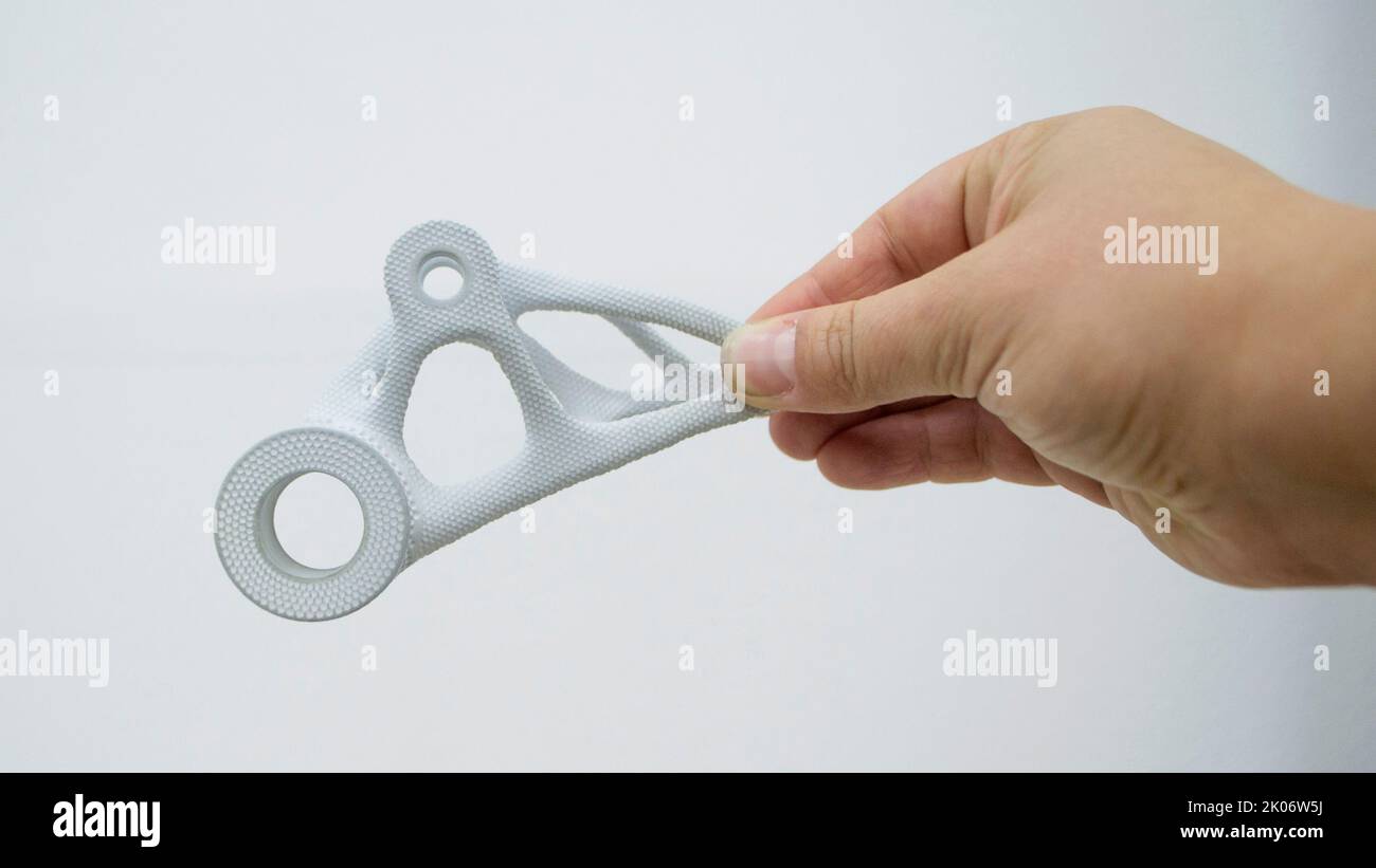 Person holding plastic model printed on powder 3d printer from biocompatible polyamide powder. Multi Jet Fusion MJF. New modern industrial 3D printing technology. Progressive additive technologies Stock Photo