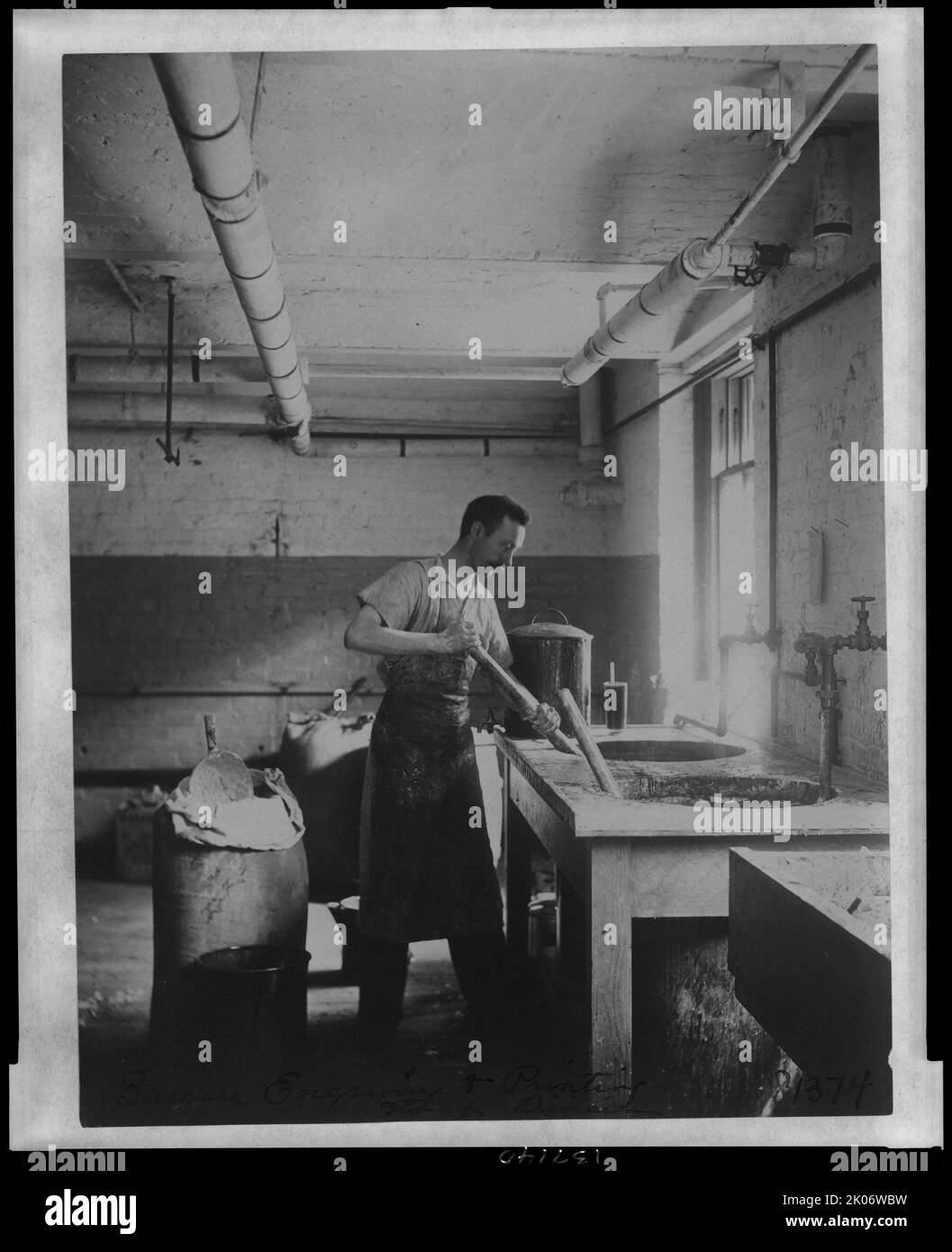 Worker prepares gum for postage stamps in the Stamp Division at the Bureau of Engraving &amp; Printing, c1895. Stock Photo