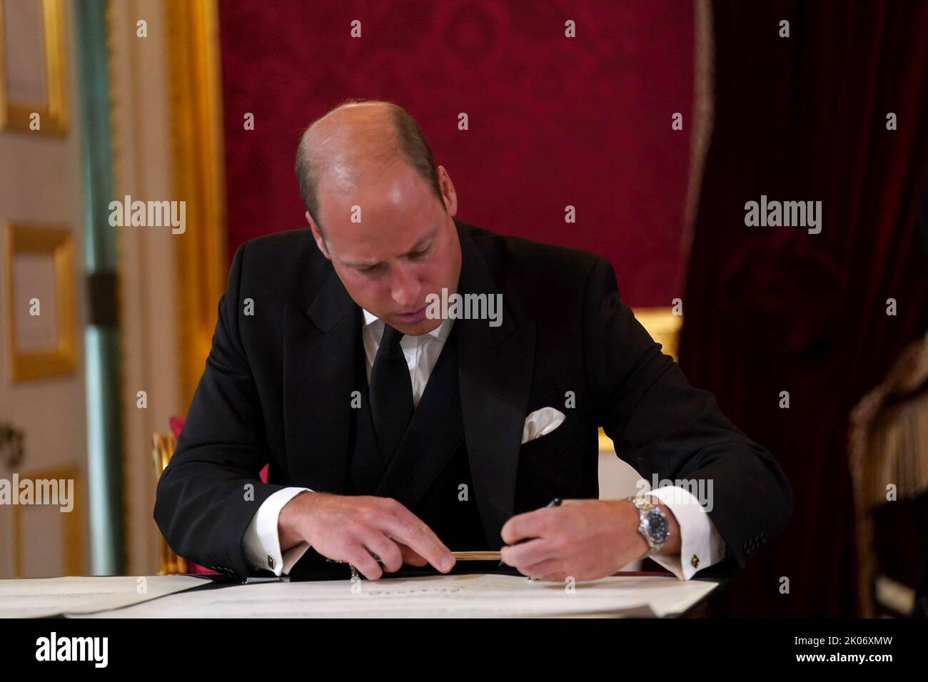 The Prince of Wales signs the oath to uphold the security of the Church in Scotland during the