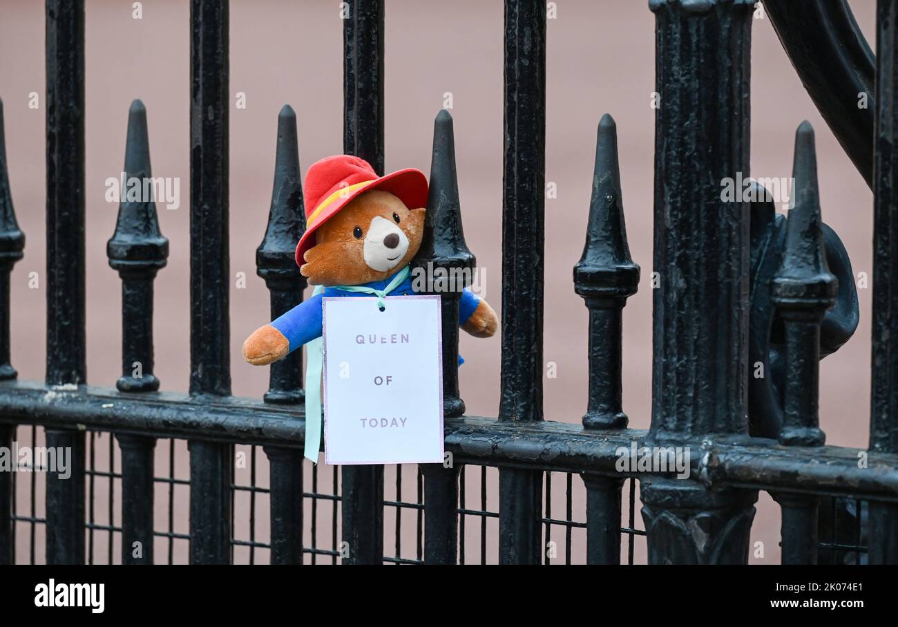 London UK 10th September 2022 - a Paddington Bear is left on the railings as crowds pay their respects and continue to bring flowers outside Buckingham Palace in London today after the death of Queen Elizabeth II . King Charles III was also proclaimed as monarch today : Credit Simon Dack / Alamy Live News Stock Photo