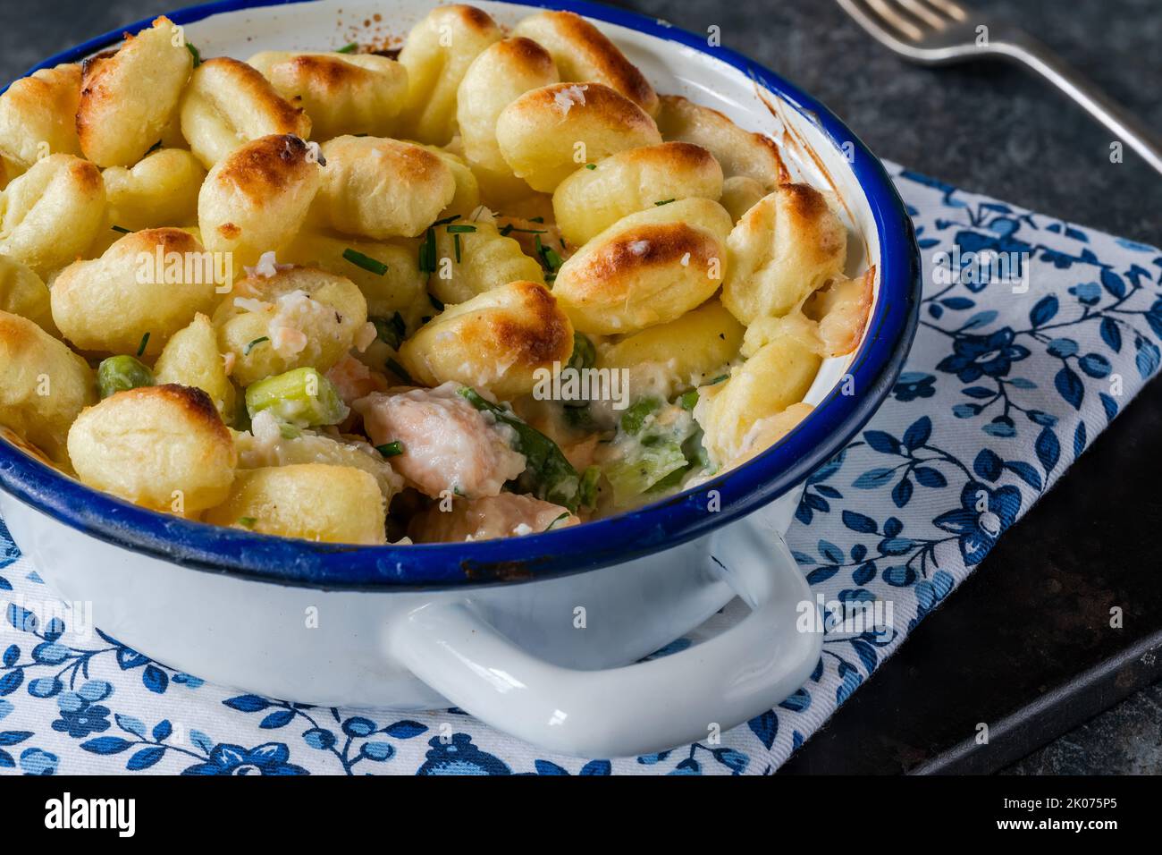 Fish pie with baked potato gnocchi topping Stock Photo - Alamy