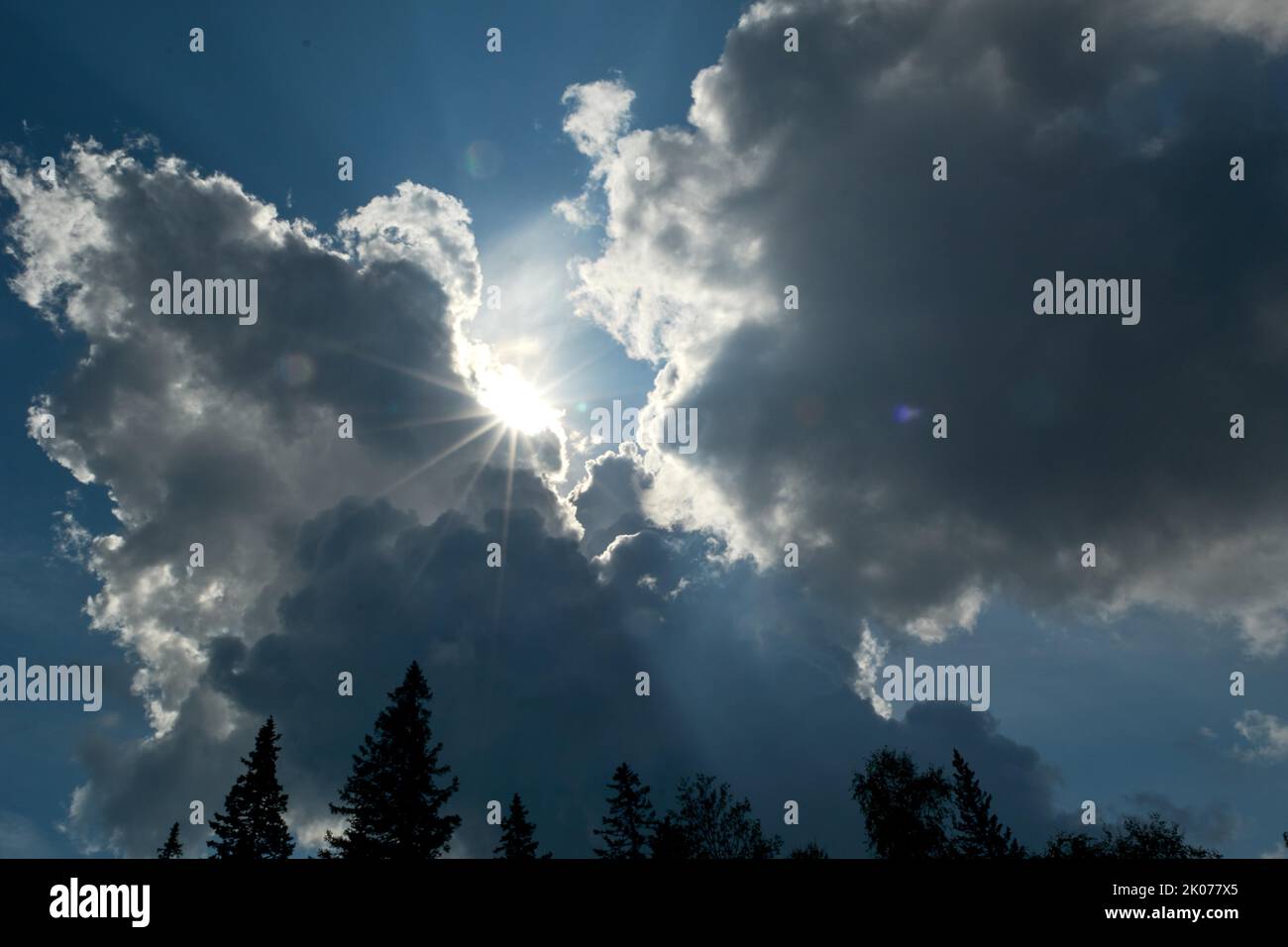 Beam of light through the clouds. Rays of light shining through dark clouds, dramatic sky with cloud Stock Photo