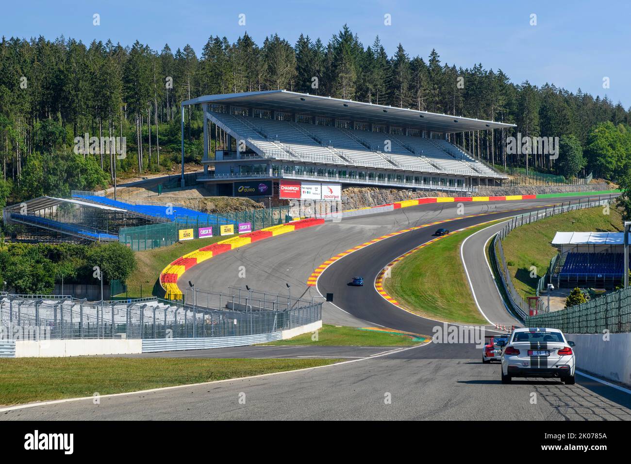 View from the perspective of a racing driver in front of overtaking in the dangerous Eau Rouge bend, behind it the 40-metre-high Raidillon slip road Stock Photo