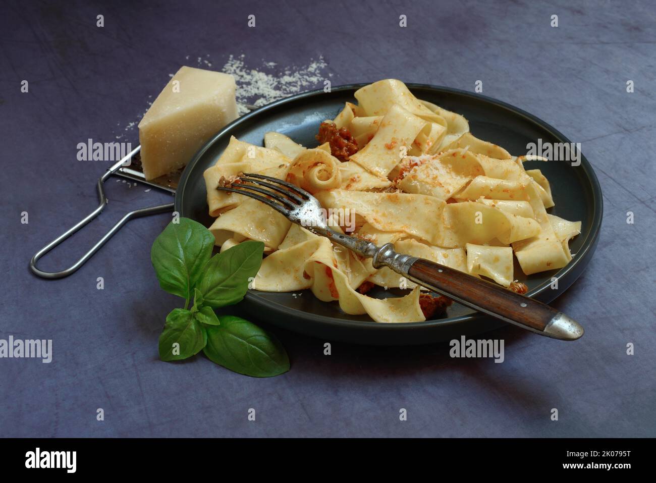 Pappardelle, cooked, wide Italian ribbon noodles with Bolognese sauce ...