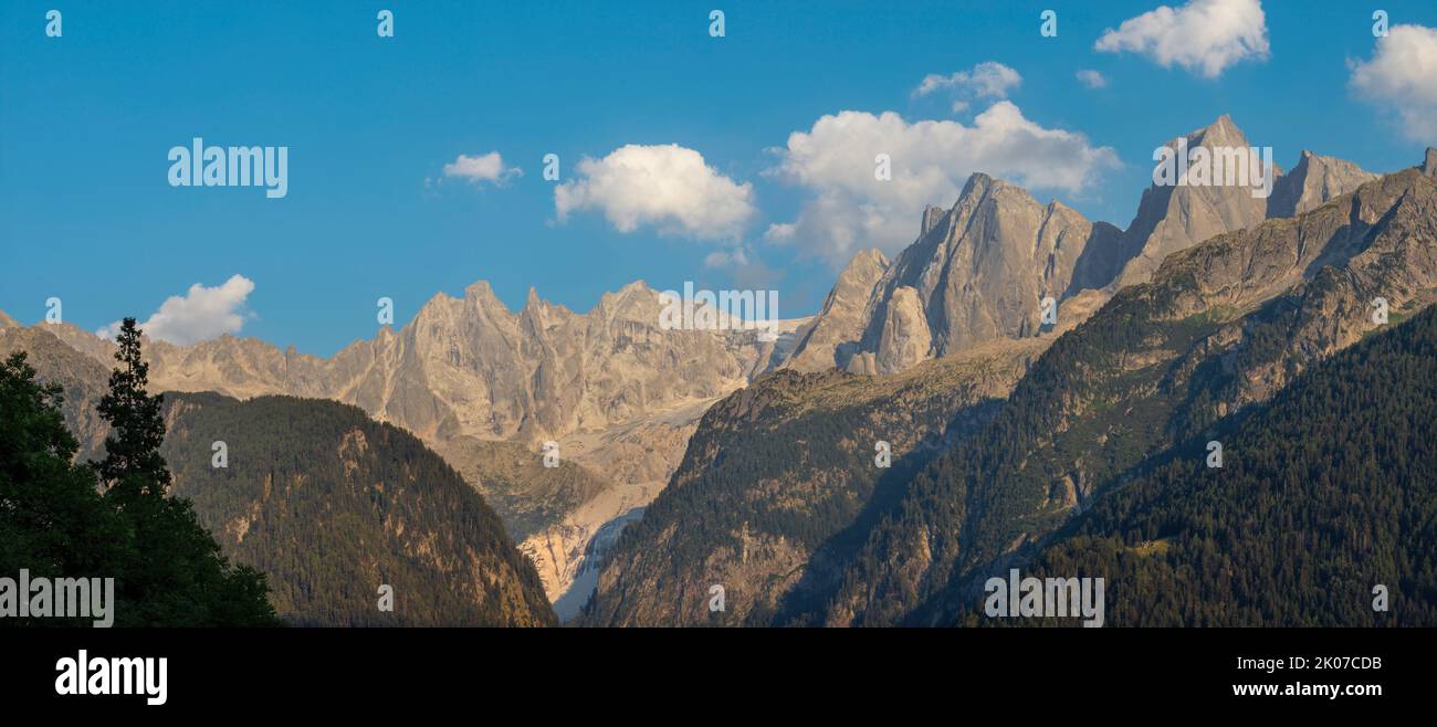 The Piz Badile, Pizzo Cengalo, and Sciora peaks in the Bregaglia range - Switzerland in evening light. Stock Photo
