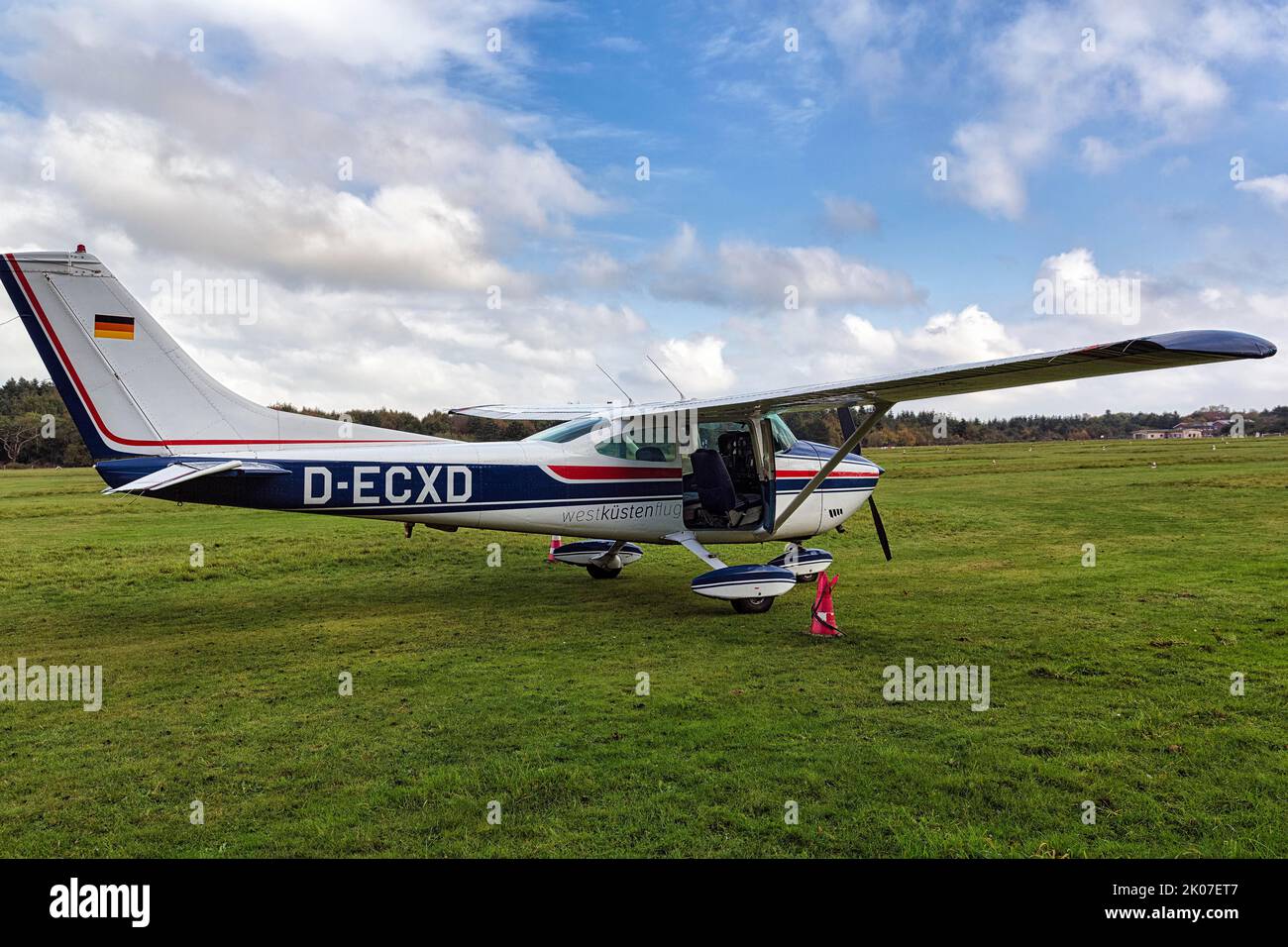 Cessna, light aircraft stands by on grass field at airport, Wyk