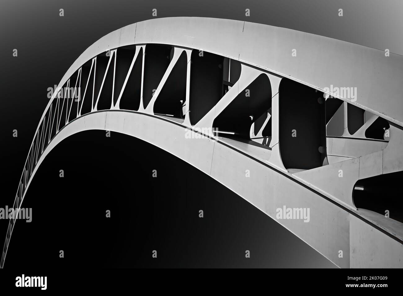 Abstract black-and-white image of arch of modern steel bar arch bridge, isolated Stock Photo