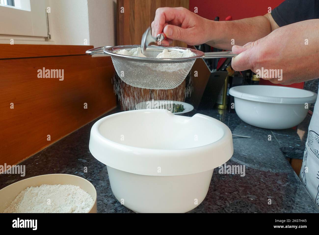 Mixing together ingredients of hot-water crust pastry dough, using wooden  spoon Stock Photo - Alamy