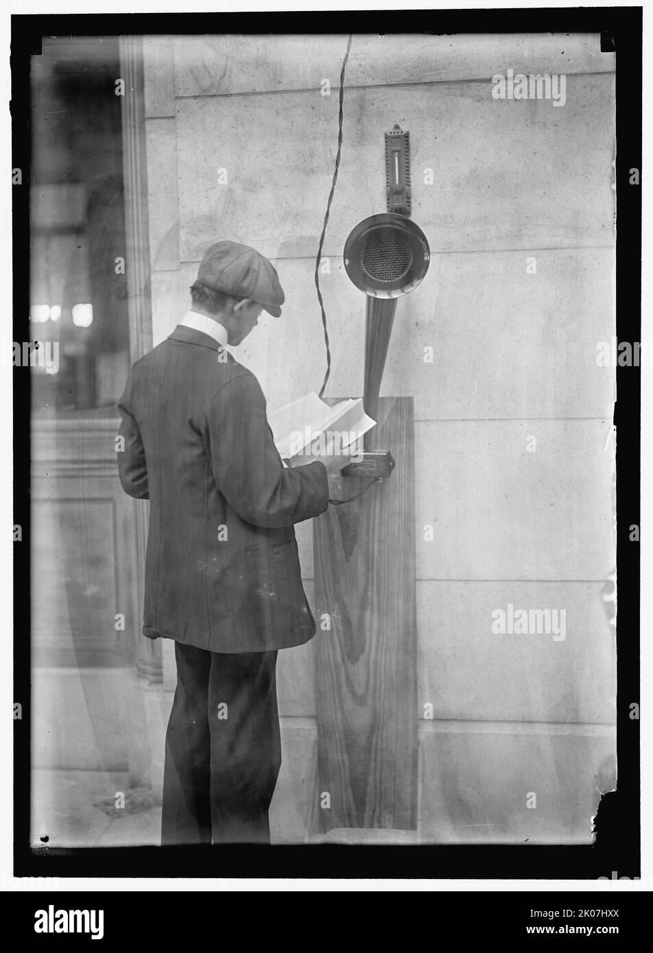 Young man standing near speaker, between 1910 and 1917.  'Manufactured by The Magnaphone Co. New York City. Patented'. Stock Photo