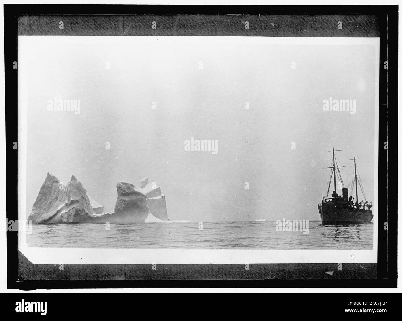 Ship at sea near iceberg, between 1910 and 1917. Stock Photo