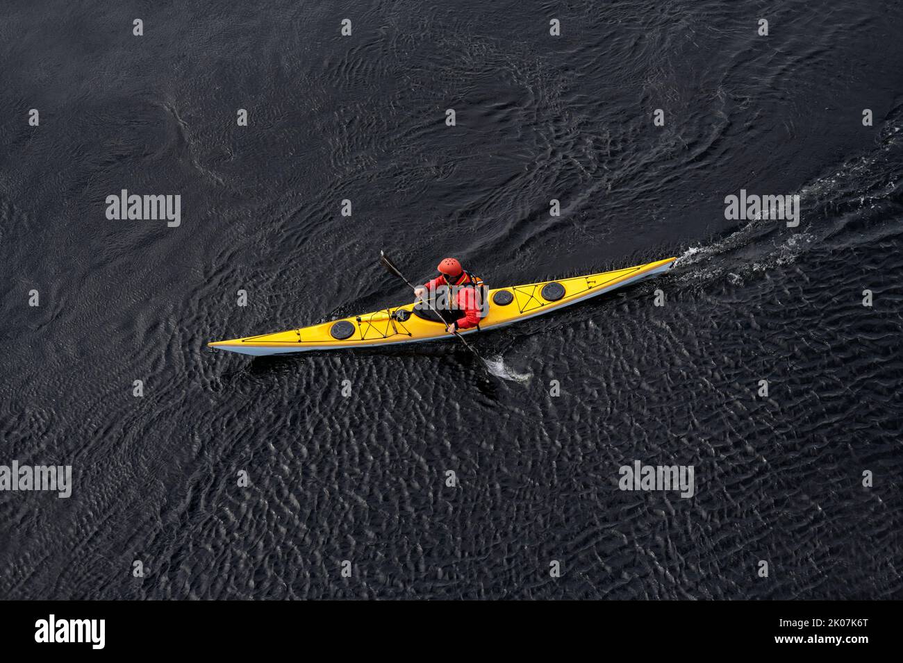 Blue and yellow kayak on open water at Loch Lomond Stock Photo