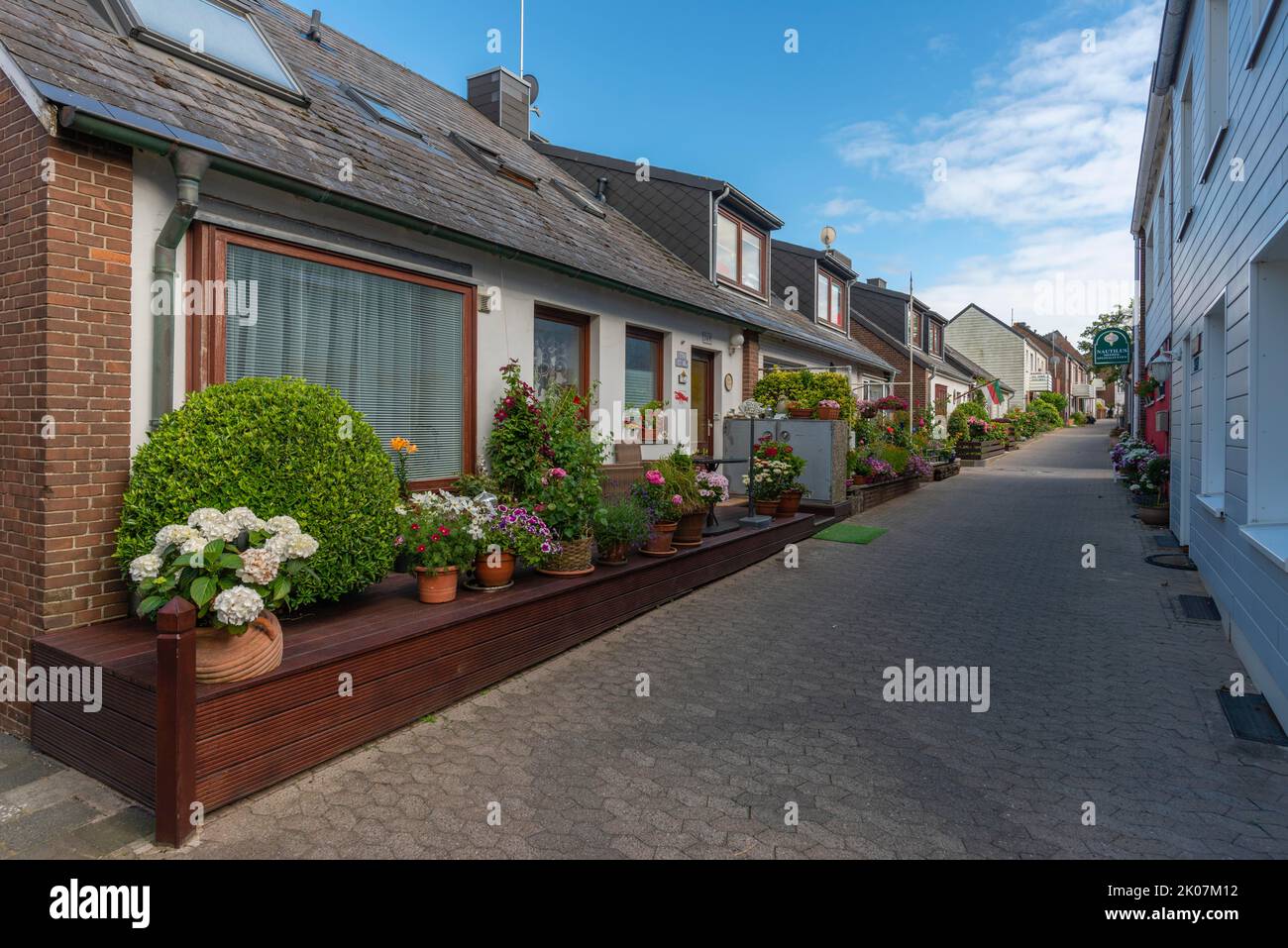 Architecture in the uplands, narrow front garden, flower pots, footpath