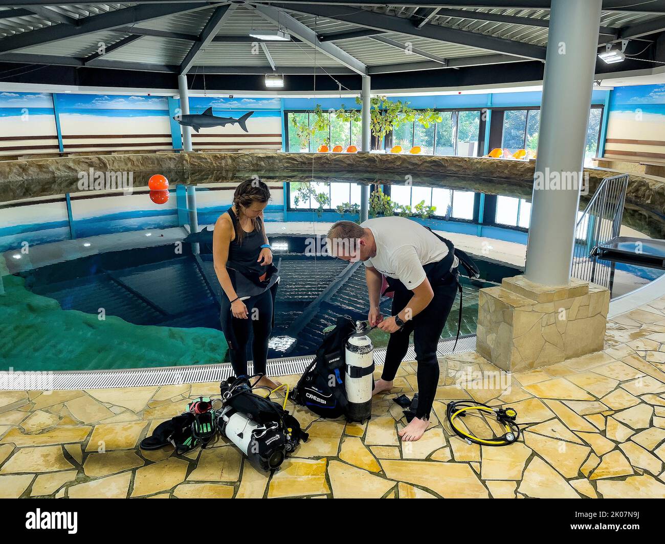 Pair of divers prepare dive equipment for dive in indoor diving tower, Indoor Dive Centre Dive4Life, Siegburg, North Rhine-Westphalia, Germany Stock Photo