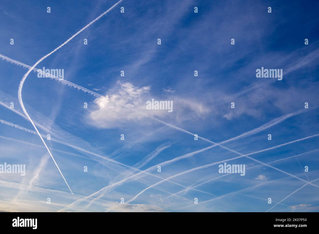 Blue sky with many contrails or chemtrails Stock Photo