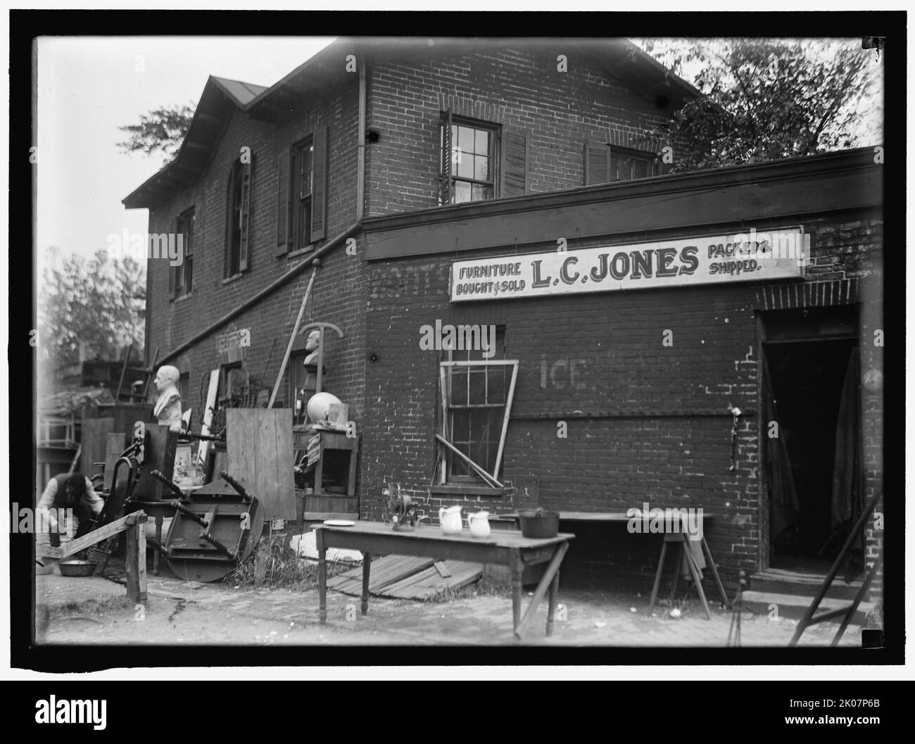 L.C. Jones Furniture, between 1911 and 1920. Bric-a-brac store, USA. Sign reads: 'Furniture Bought &amp; Sold - Packed &amp; Shipped'. Stock Photo