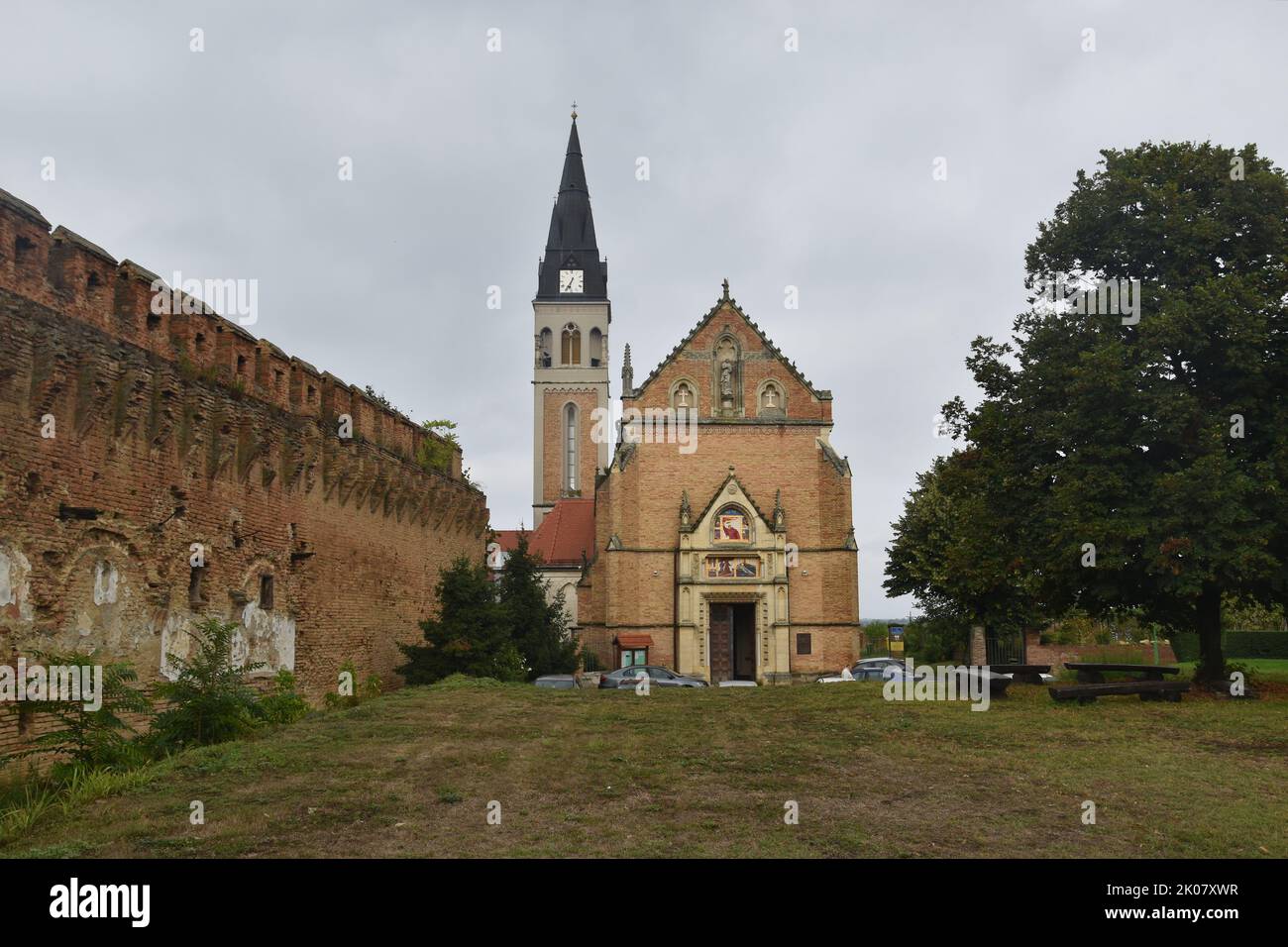 Border town of Ilok in Eastern Croatia (Slavonia, Srijem) by the Danube river: Catholic church and castle above the river Stock Photo