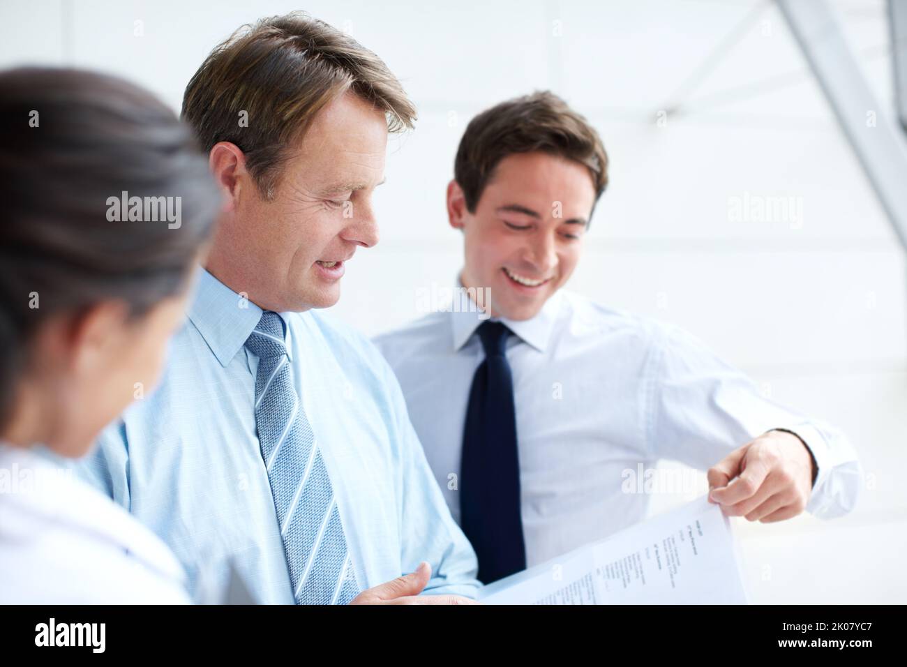 I think this plan is a definite winner. Happy business executives going through documents together in an informal meeting. Stock Photo