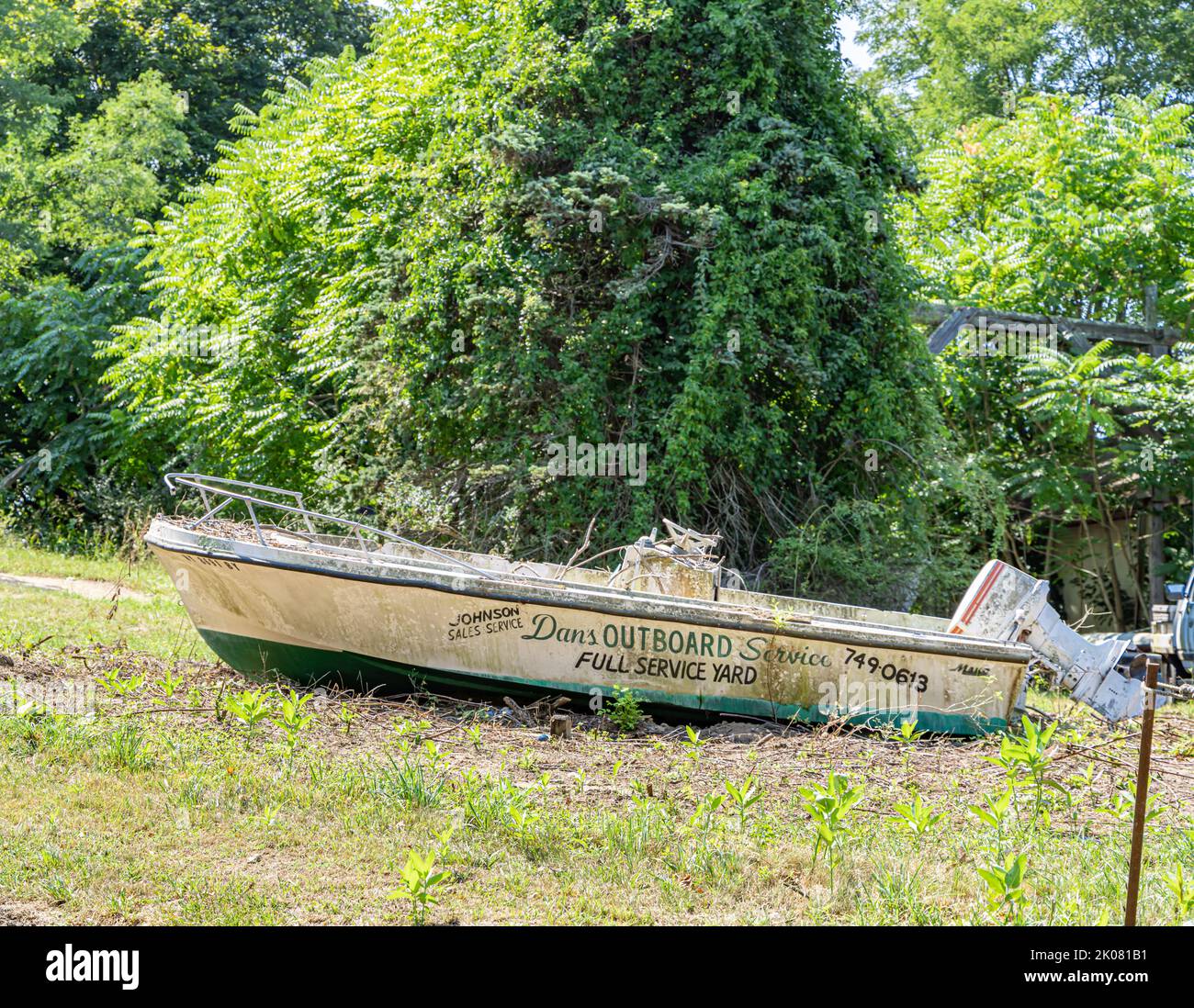 Dan's Outboard service advertised on the side of an old boat Stock Photo