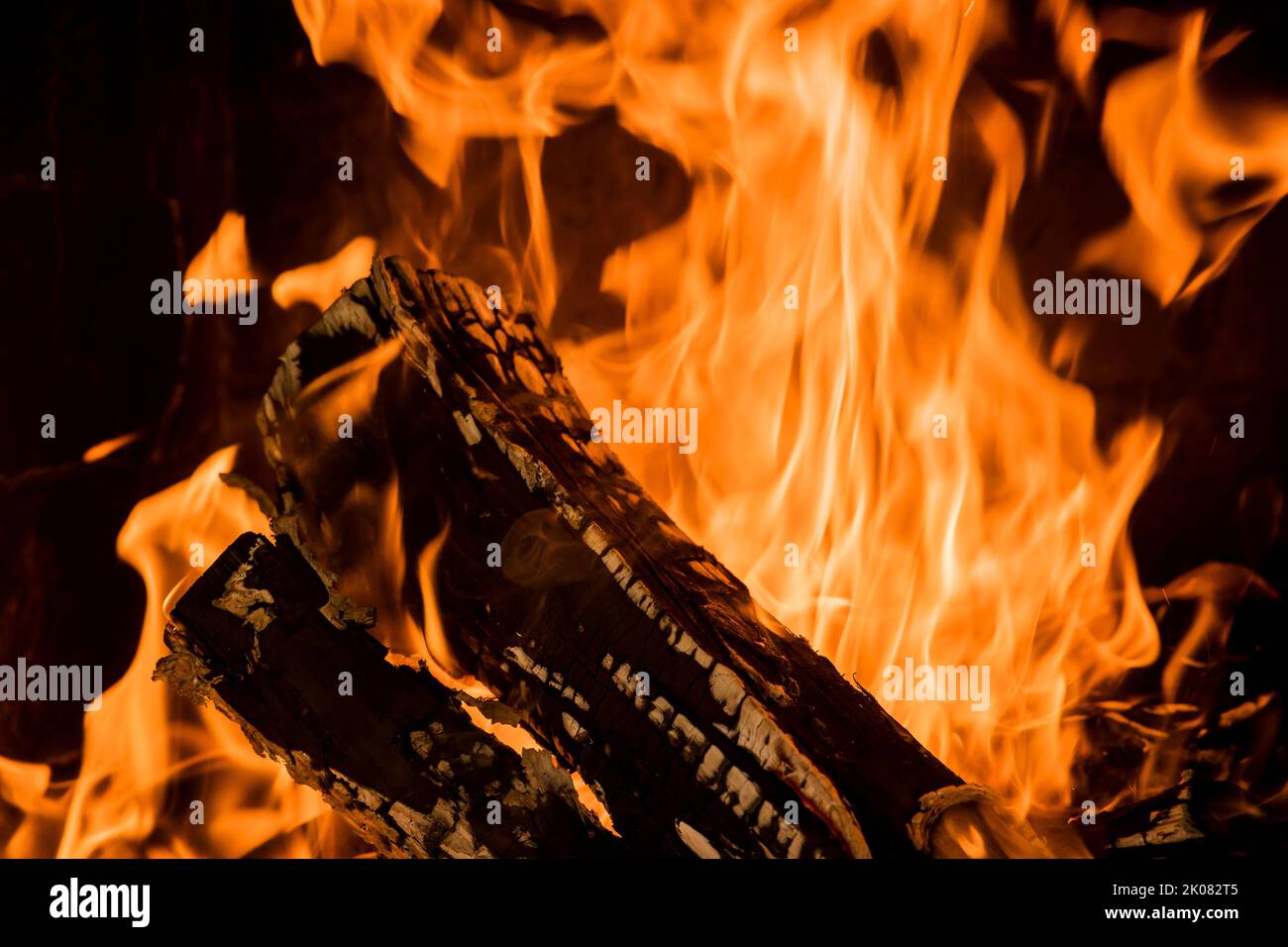 A wood-fired pizza oven is burning with flames it as a fire is burning Stock Photo