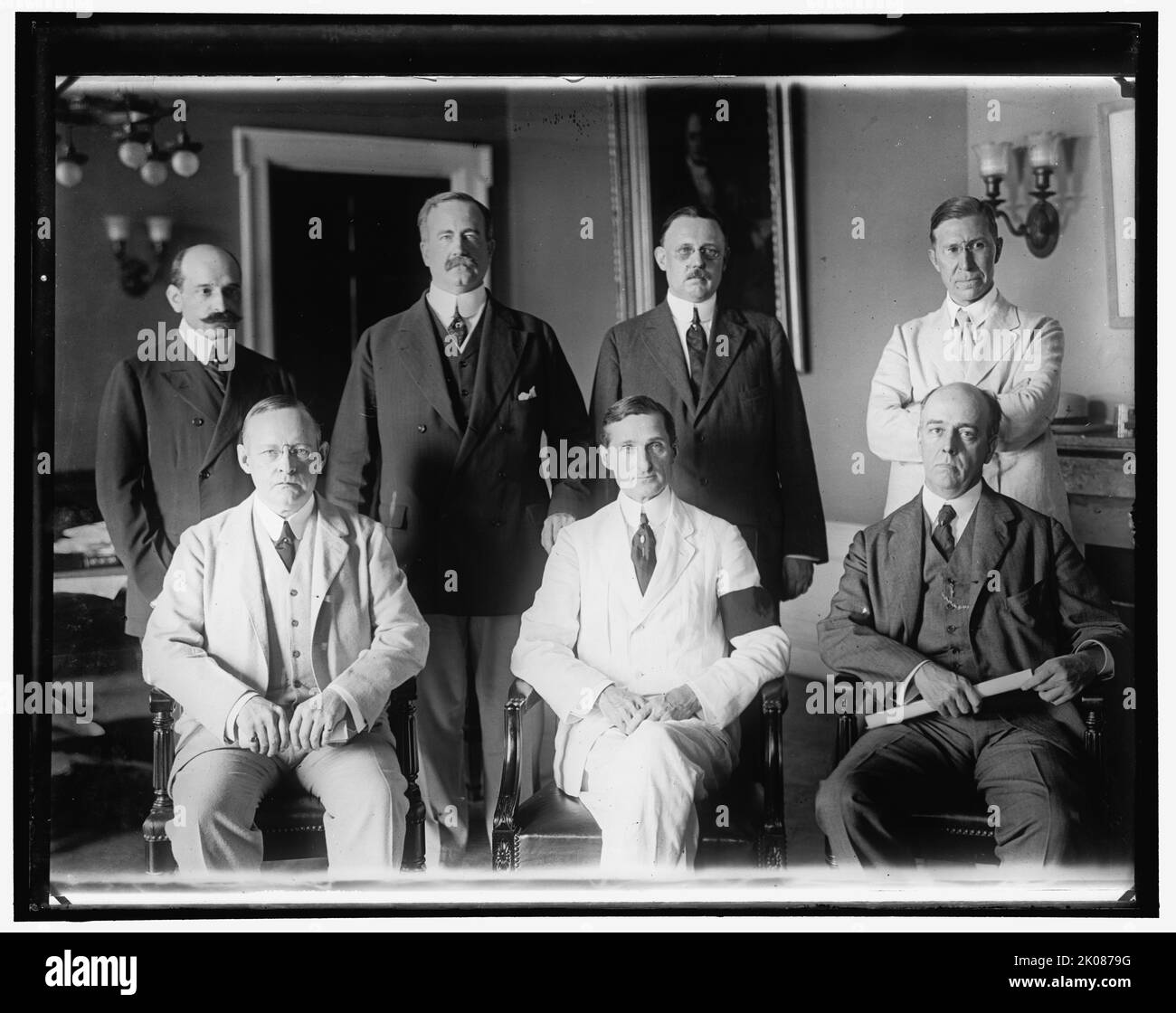 Group: William Gibbs McAdoo, center front, between 1910 and 1920. American lawyer and politician William Gibbs McAdoo Jr. was the husband of Eleanor Wilson McAdoo, (daughter of president Woodrow Wilson). He is pictured wearing a black armband, a sign of mourning. Stock Photo