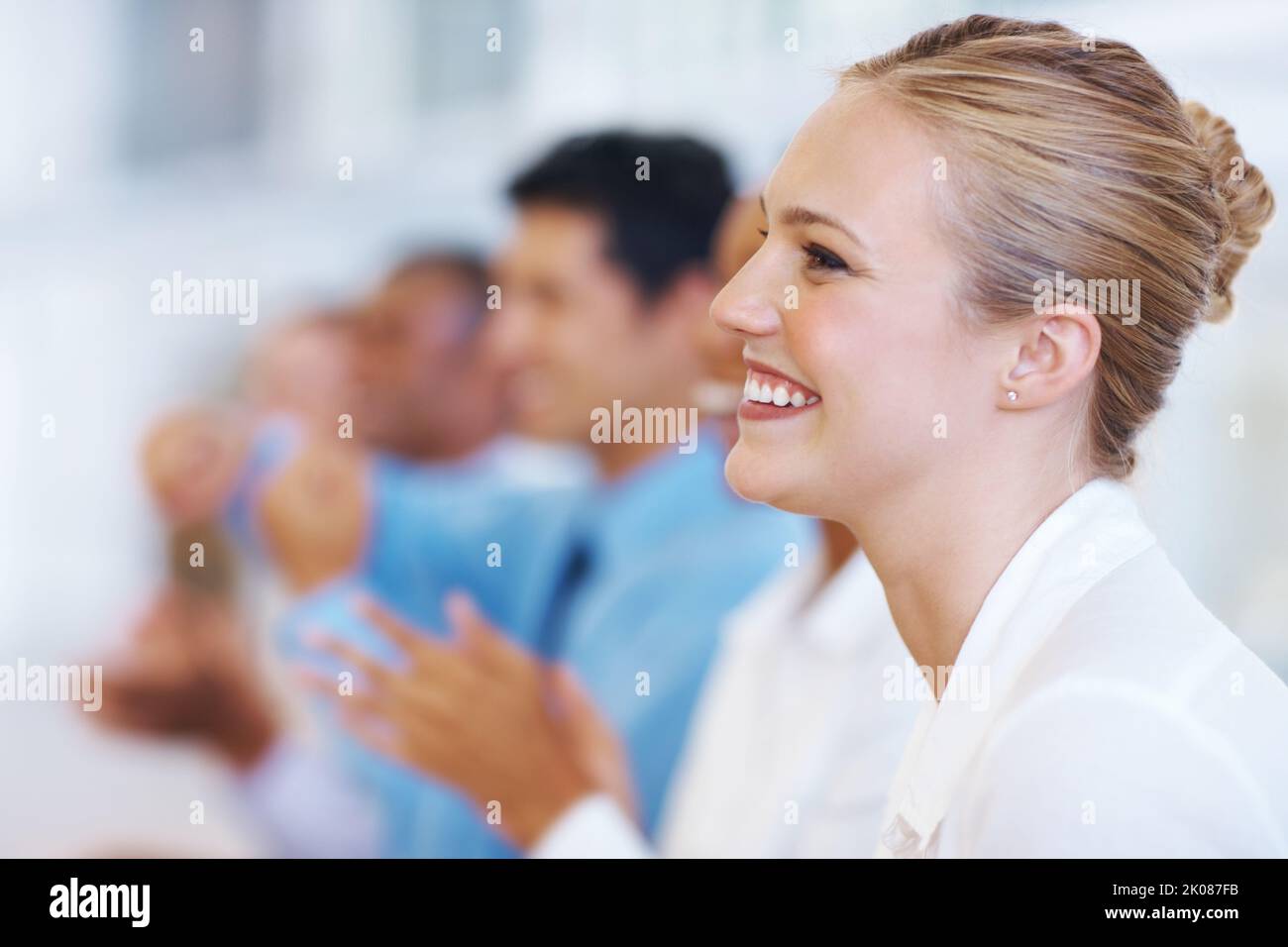 Business appreciation. Closeup of beautiful business woman with executives clapping in meeting. Stock Photo