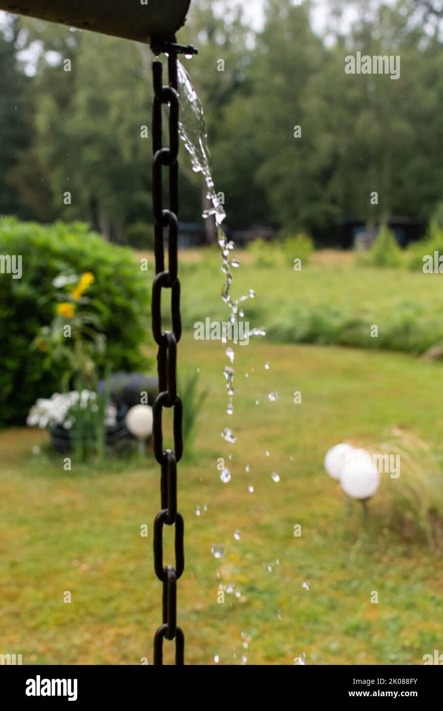 water trickling down a chain hanging from a gutter Stock Photo Alamy