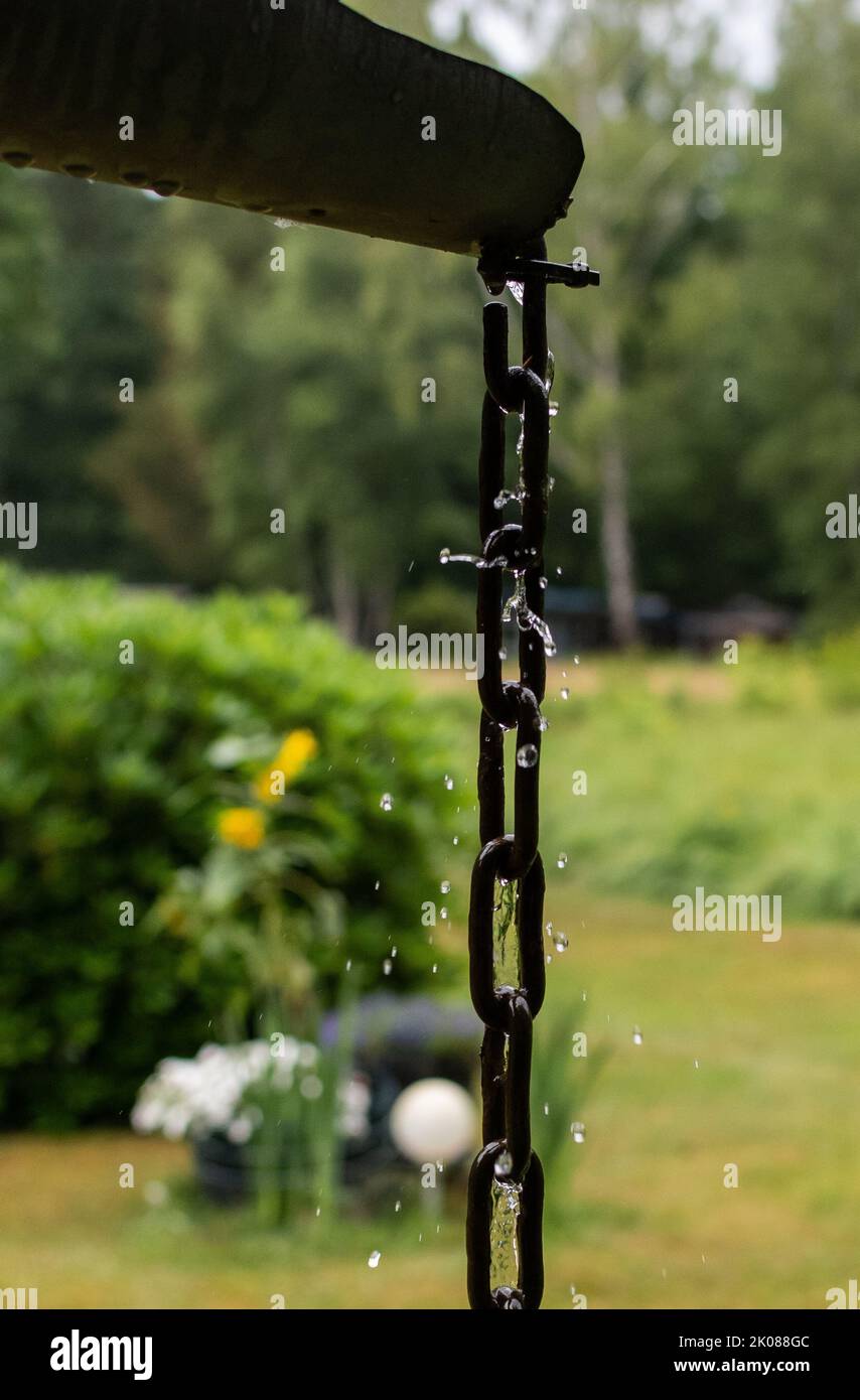water trickling down a chain hanging from a gutter Stock Photo Alamy