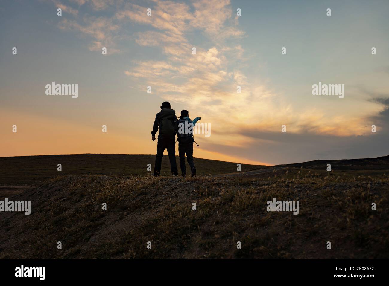 Hiking pointing sunset couple hi-res stock photography and images - Alamy