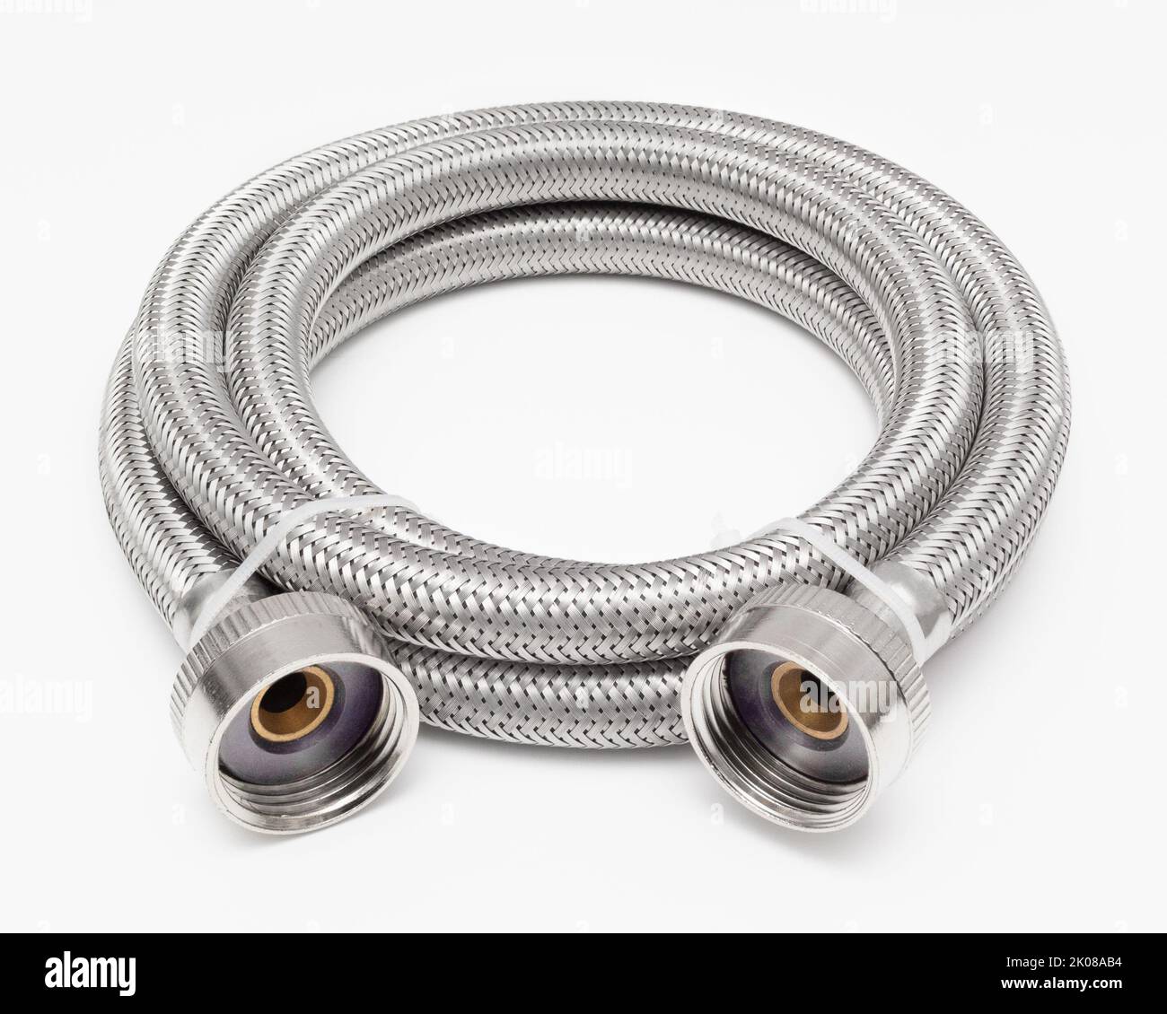 Flexible metal plumbing hose on white surface Stock Photo