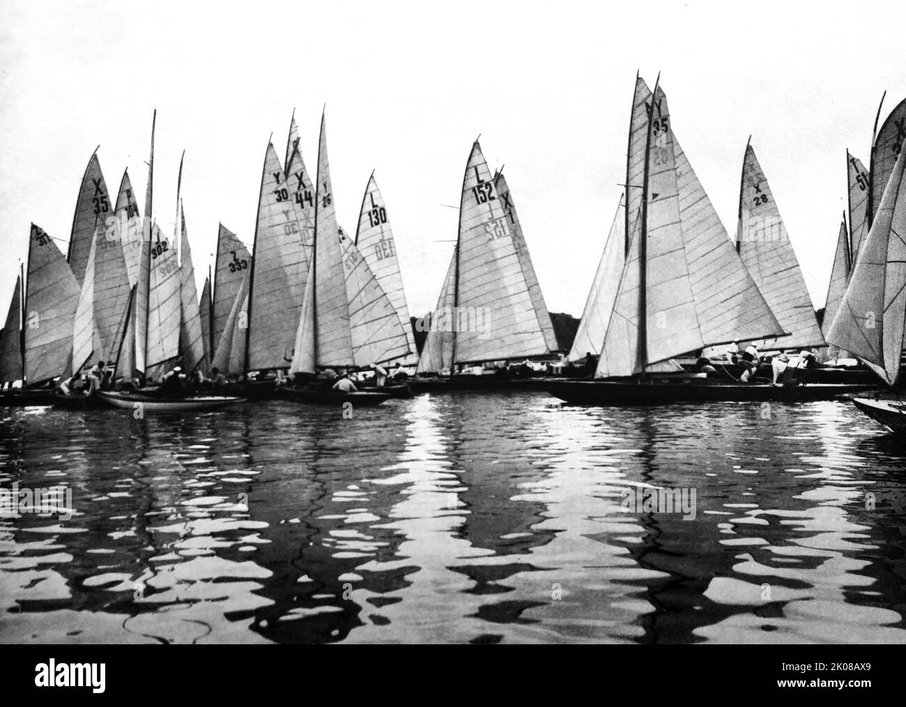 Water but no wind. Seven different classes of racing yachts at close quarters on a German lake Stock Photo