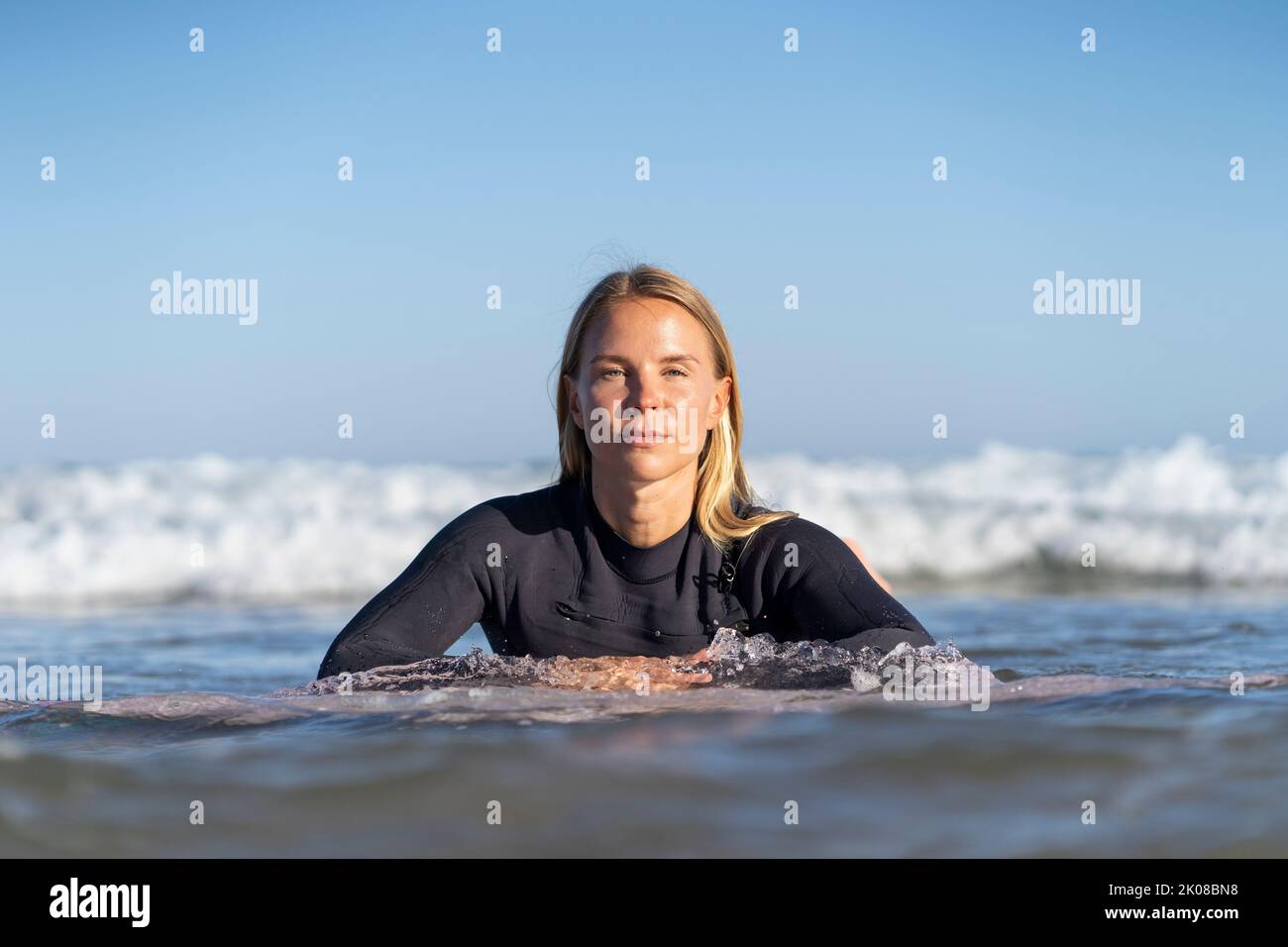 Beatiful surfer girl in the water. Female surfer woman Stock Photo