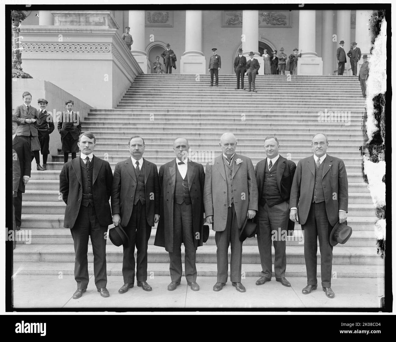 Fraternity Group, between 1910 and 1920. Men posing at the bottom of the Capitol Building steps, Washington, D.C. Note boys in plus fours behind. Stock Photo