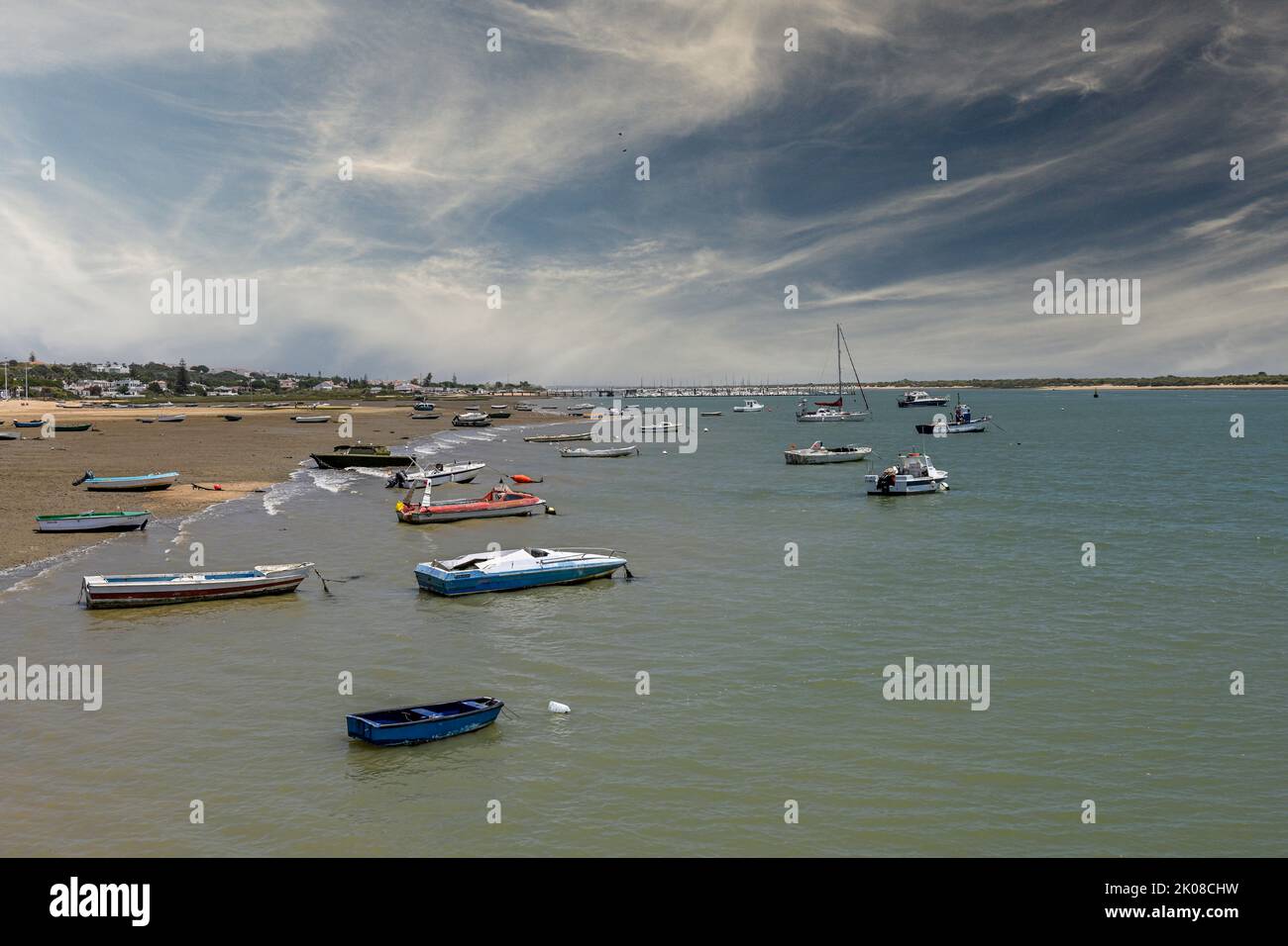 Fishing and pleasure boats anchored on the banks of a river Stock Photo ...