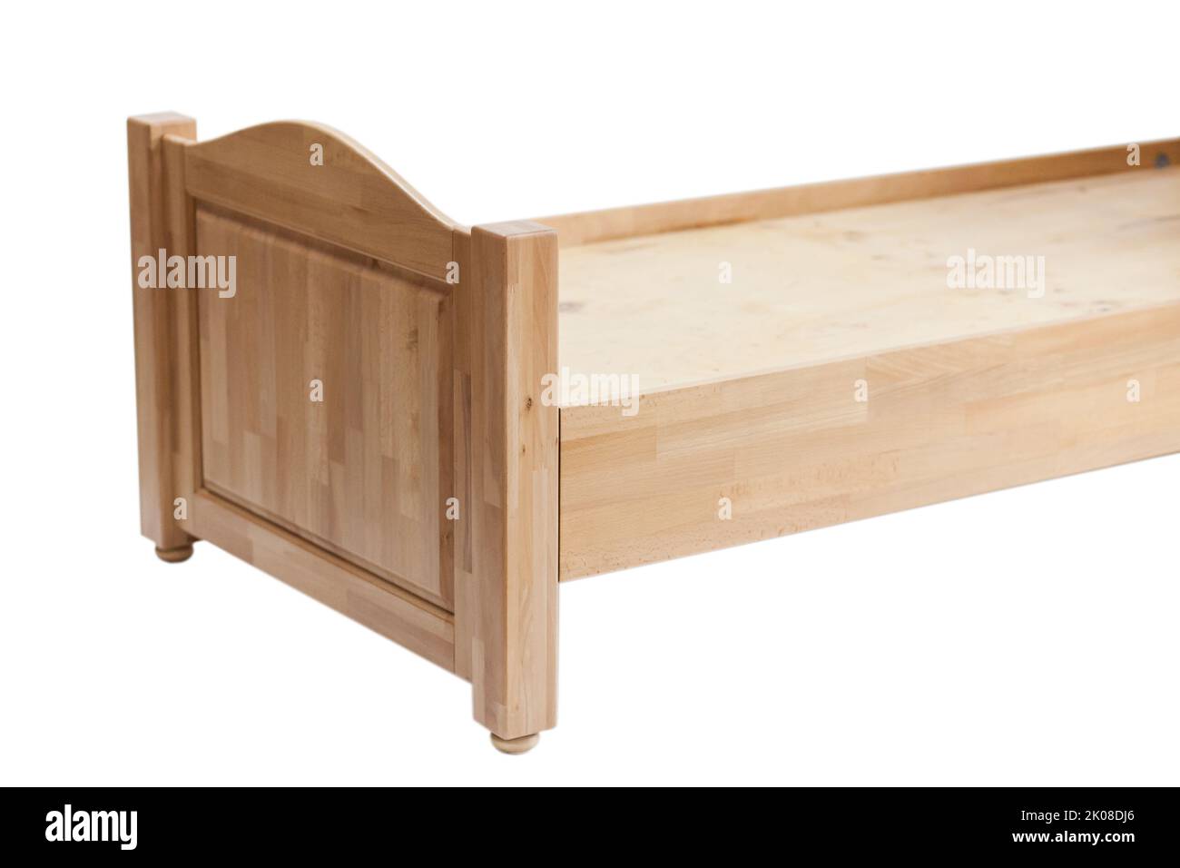 Close-up of a part of a wooden bed for sleeping. Classic sleeping bed furniture made of natural wood. New wooden bed frame on white background view si Stock Photo