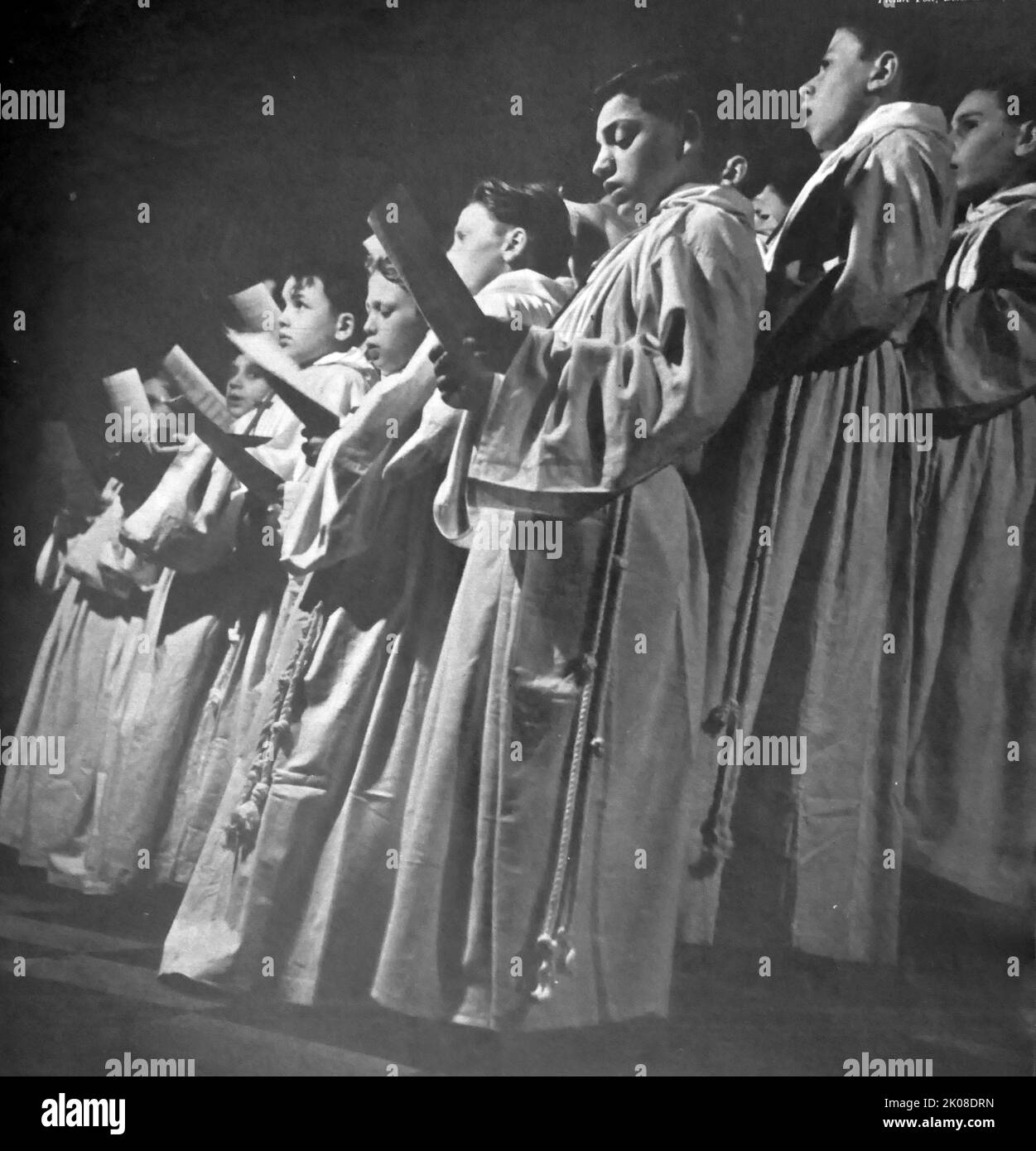 The Wooden Cross. Back and white photograph of men, women and children singing old Chrismas songs and carols Stock Photo