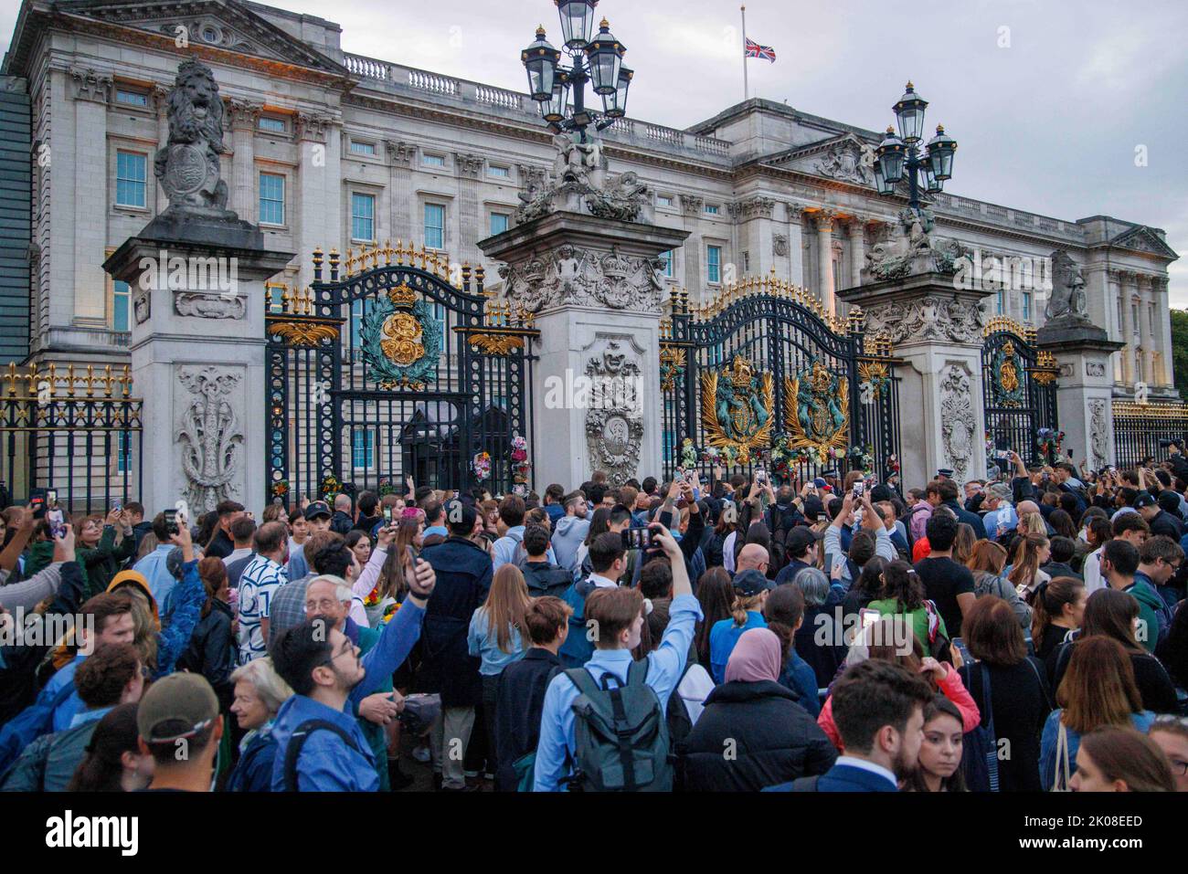 Flowers are placed at the gates of Buckingham Palace as news of the