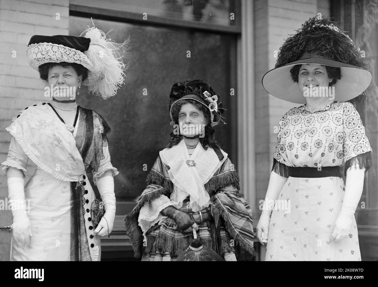 Dolly Madison Breakfast - Mrs. William F. Dennis; Mrs. Chase Riker; Mrs. Mann Barker, 1912. Society occasion, USA. Wives of influential men - the older woman is wearing late 19th century bonnet and dress while her companions wear wide-brimmed hats. Stock Photo