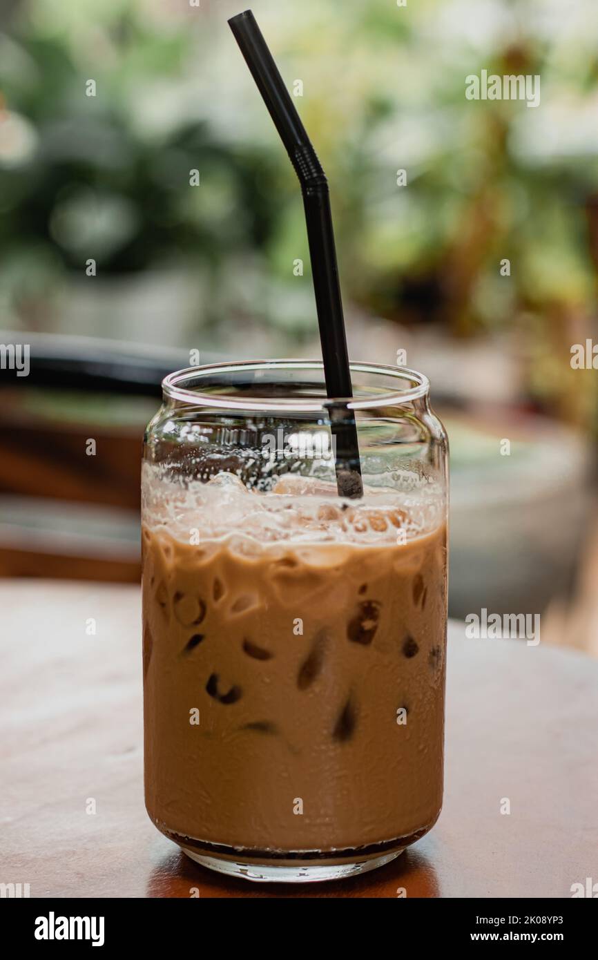 An iced latte drink at a garden theme cafe for cooling down during summer heat Stock Photo