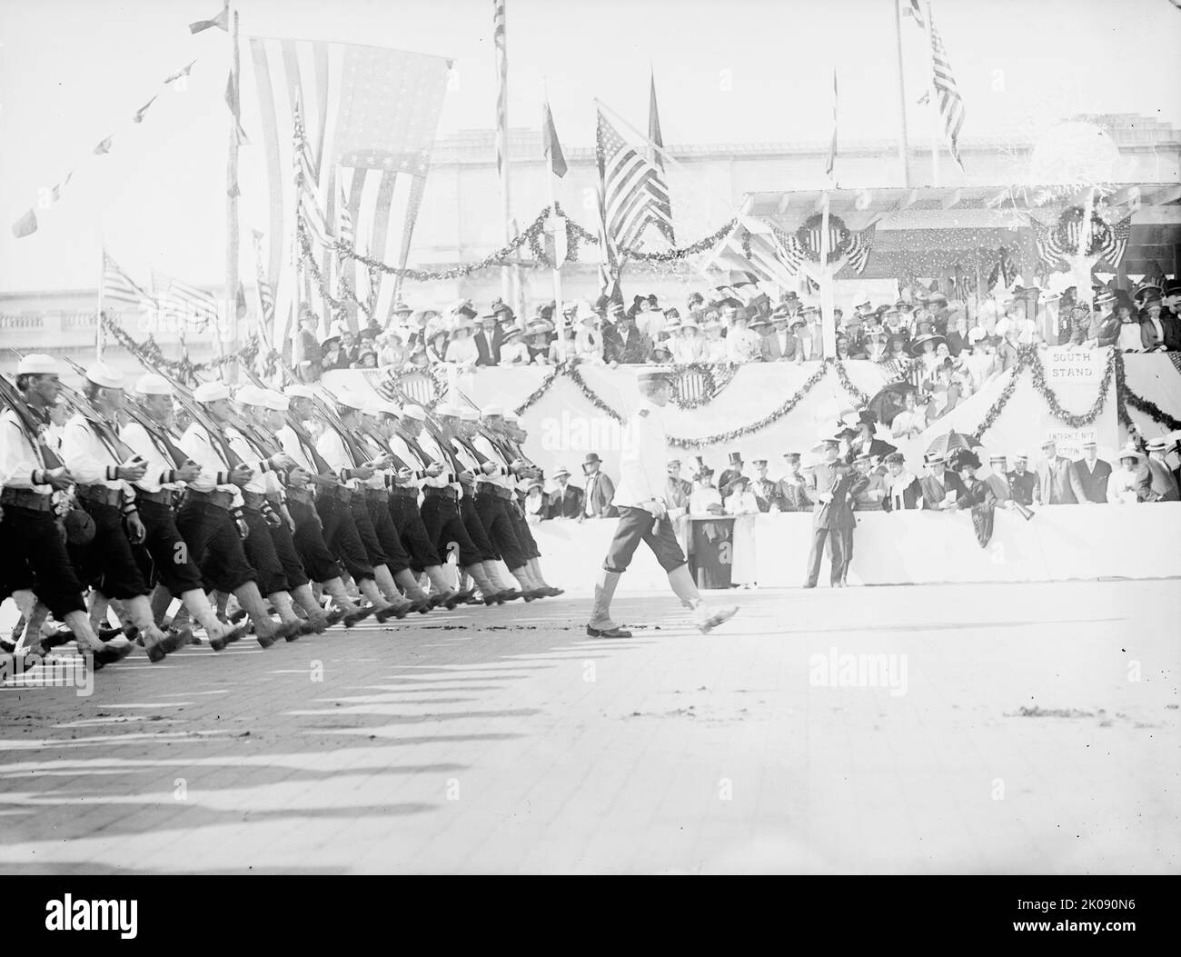 Columbus Memorial. Parade At Unveiling, 1912. [The Columbus Fountain, also known as the Columbus Memorial, was unveiled in Washington, D.C. in 1912. It was designed by Lorado Taft. Seen here are US Navy sailors marching past a grandstand as part of the celebrations]. Stock Photo