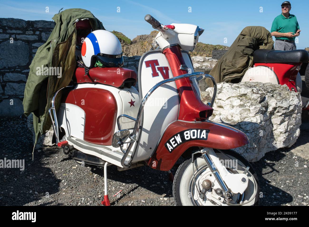 Lambretta TV Scooter Classic two tone vintage Italian design with white helmet and green parka. Ballintoy, UK - September 10th 2022. Stock Photo