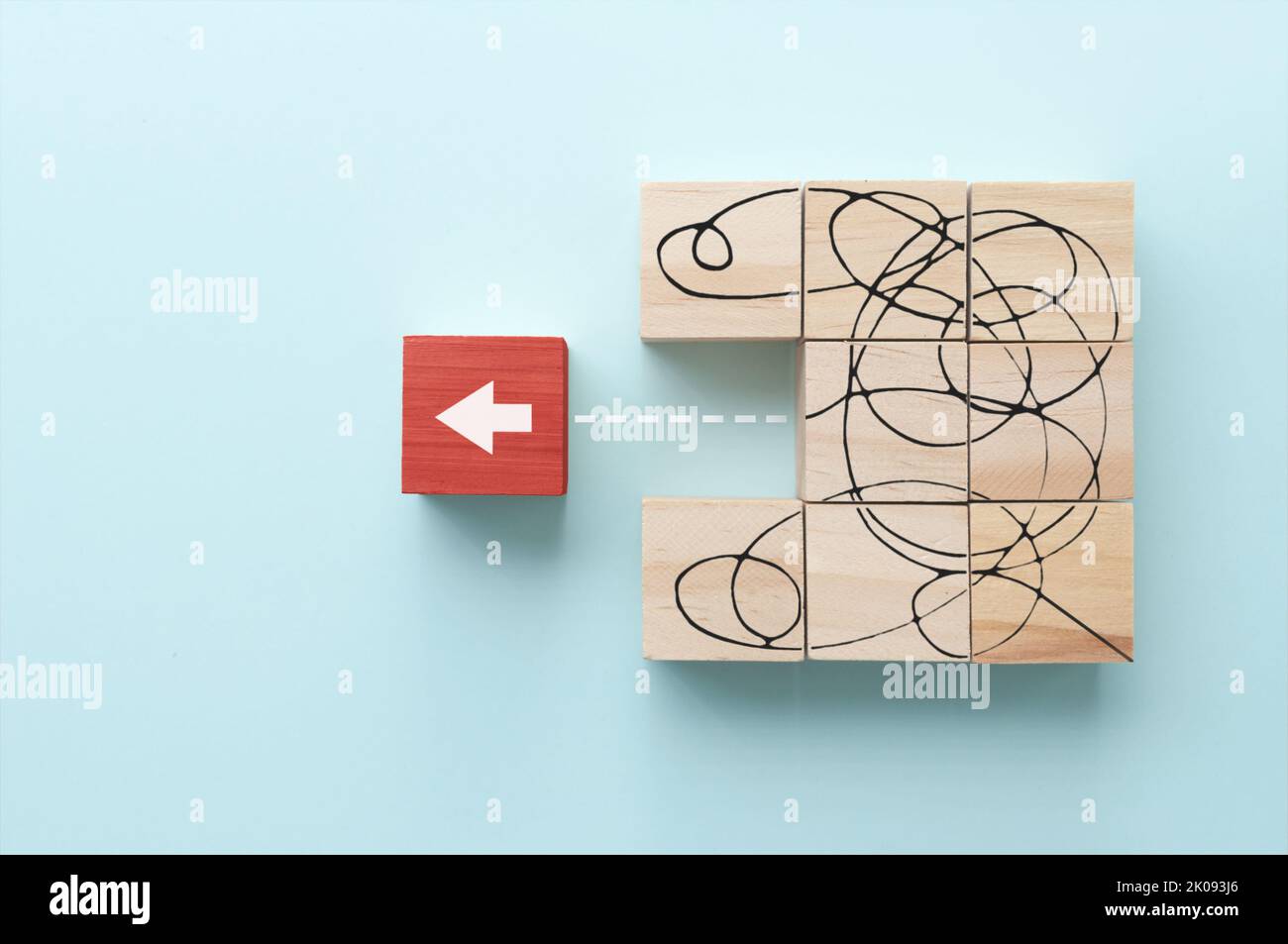 Messy line sketched on wooden blocks leading to arrow, solving complex problems, exit strategy concept Stock Photo