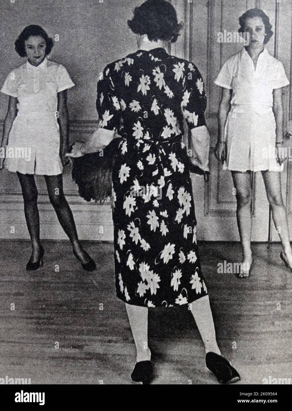 Josephine Bradley instructing debutantes in the intricacies of court curtsey, prior to their presentation, at her West End dancing school. Illustrated news cutting. Stock Photo