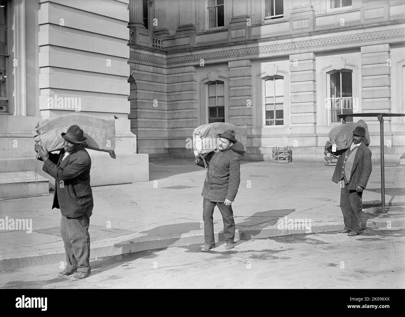 U.S. Congress, Franked Mail, [Washington, DC], 1913. [Men carrying mail sacks]. Stock Photo